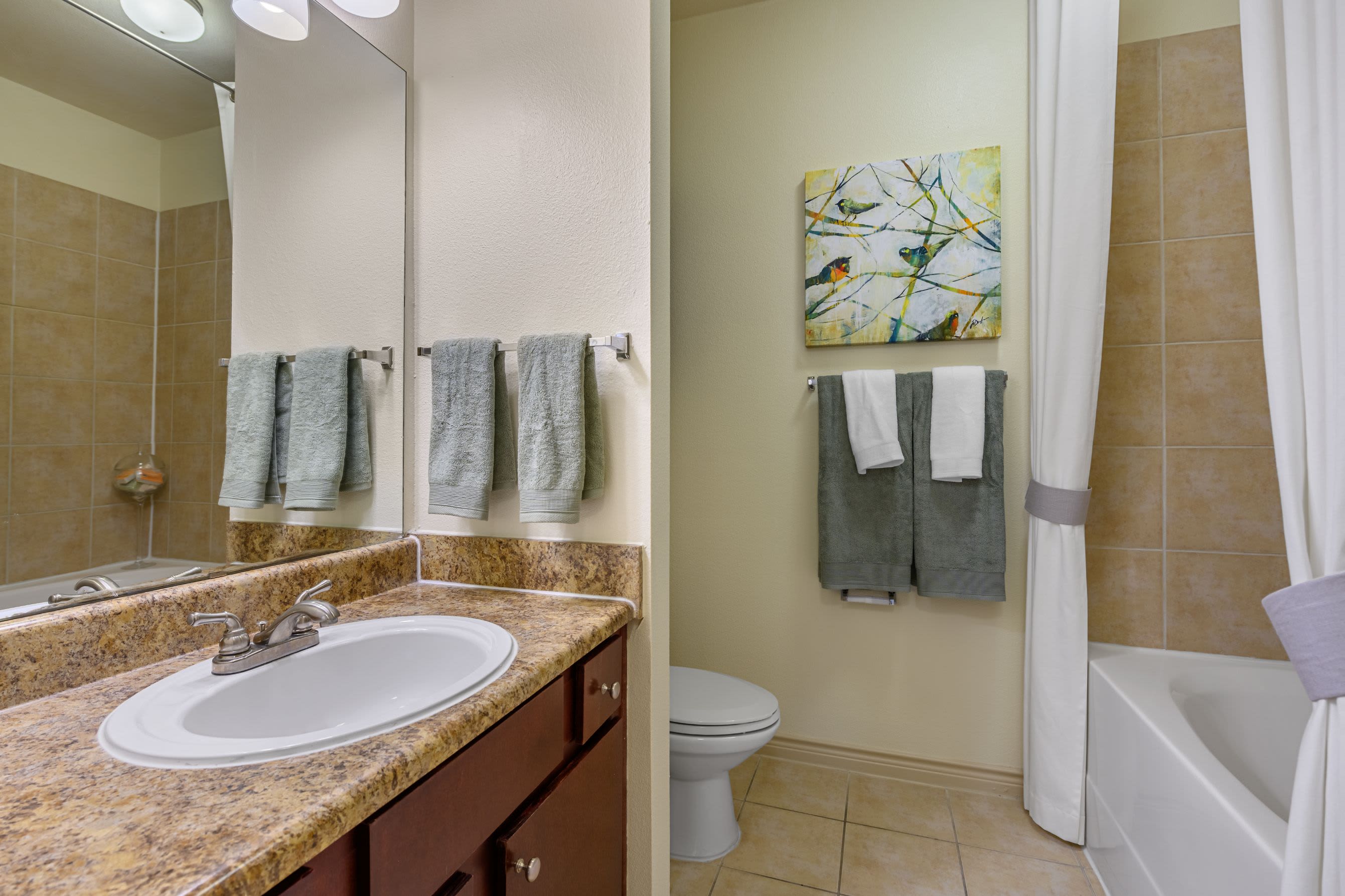 Bathroom with granite style counters at Marquis Lakeline Station in Austin, Texas
