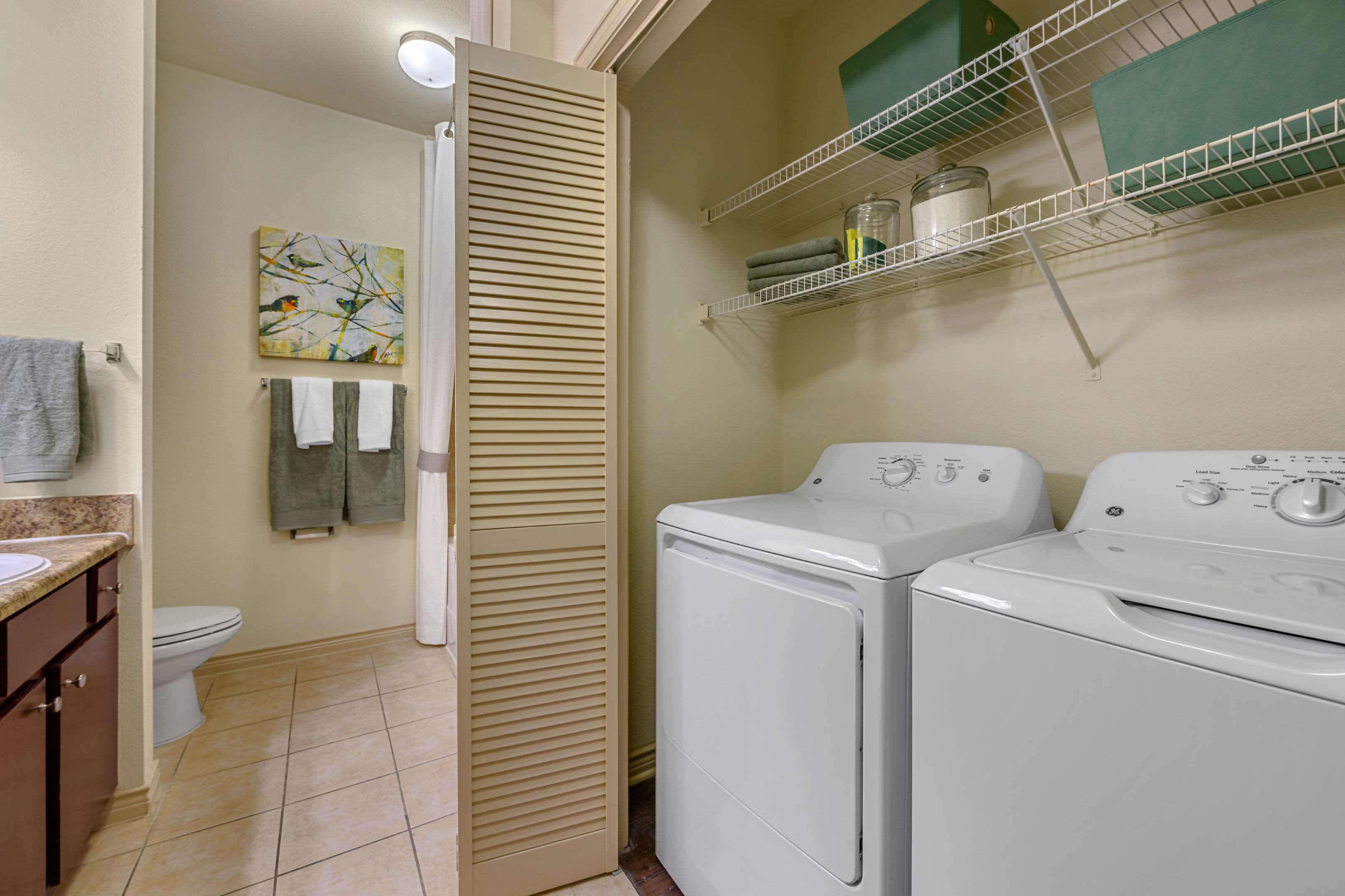 Washer and dryer in bathroom at Marquis Lakeline Station in Austin, Texas