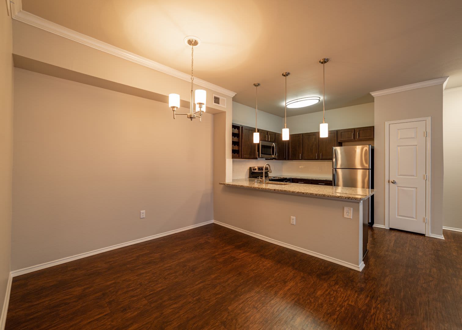 Spacious dining area next to kitchen at Marquis at Stonebriar in Frisco, Texas