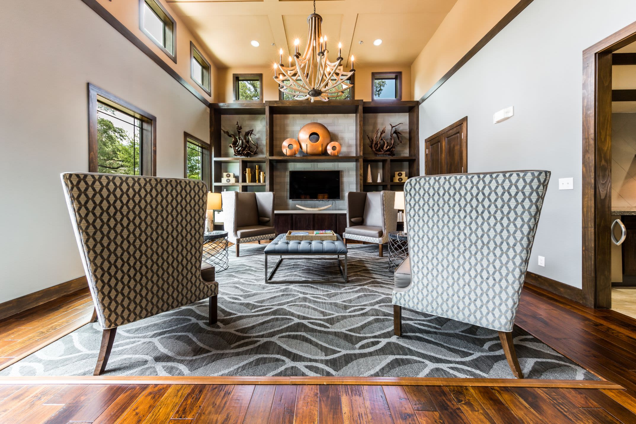 Sitting area with a large rug and a fireplace at Marquis on Lakeline in Cedar Park, Texas