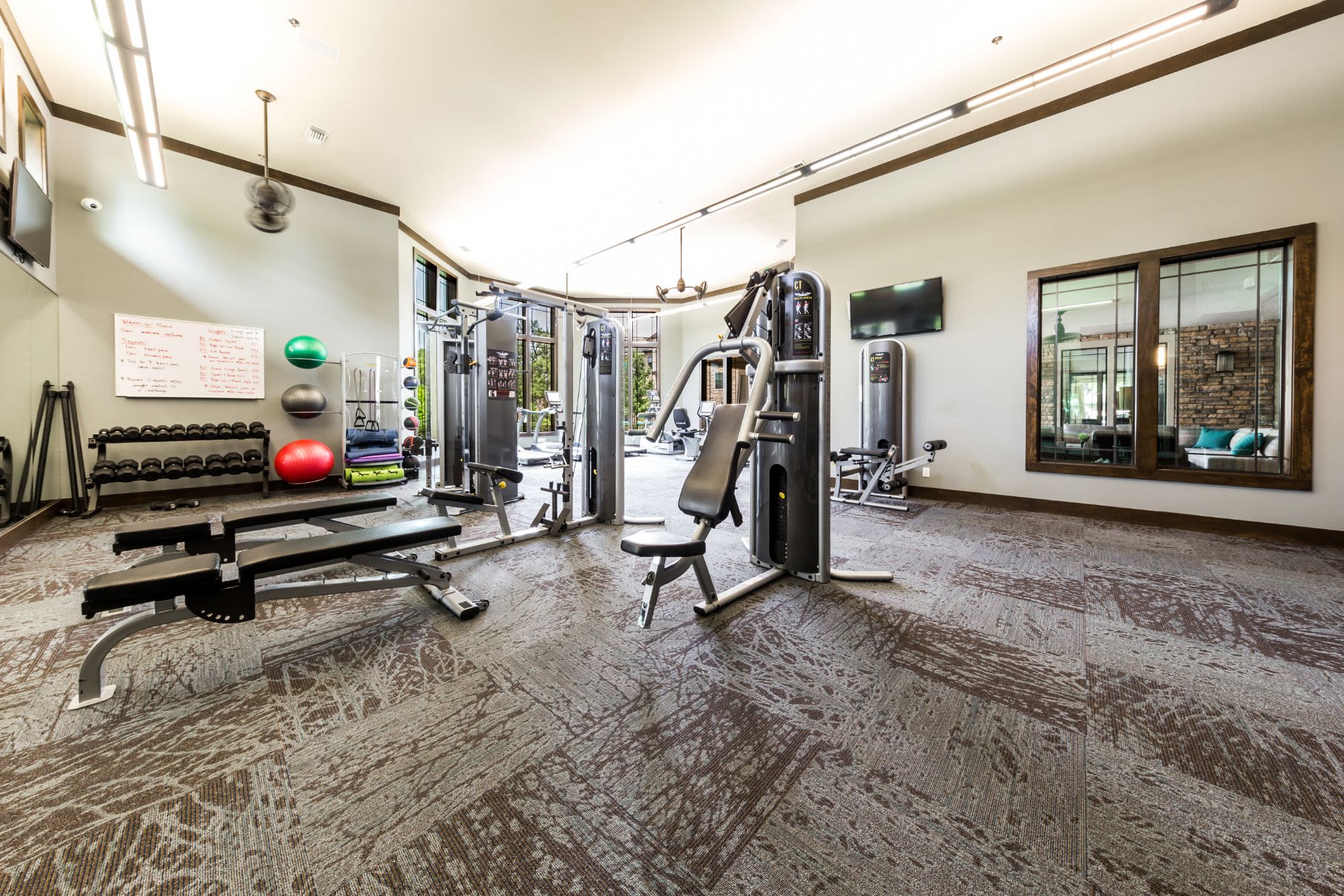 Weight machines and benches in the fitness center at Marquis on Lakeline in Cedar Park, Texas