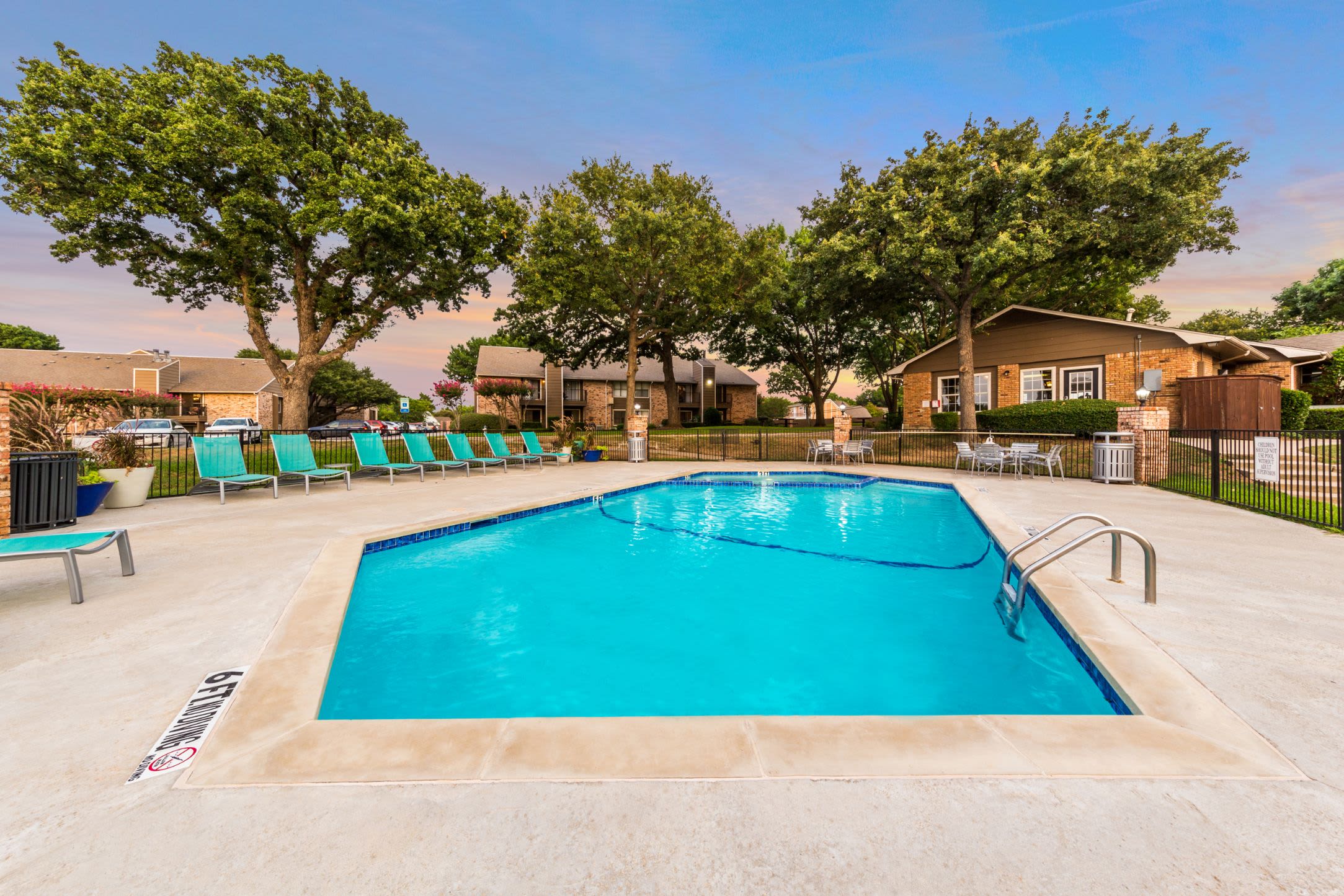 Swimming pool with trees in the background at The Park at Flower Mound in Flower Mound, Texas