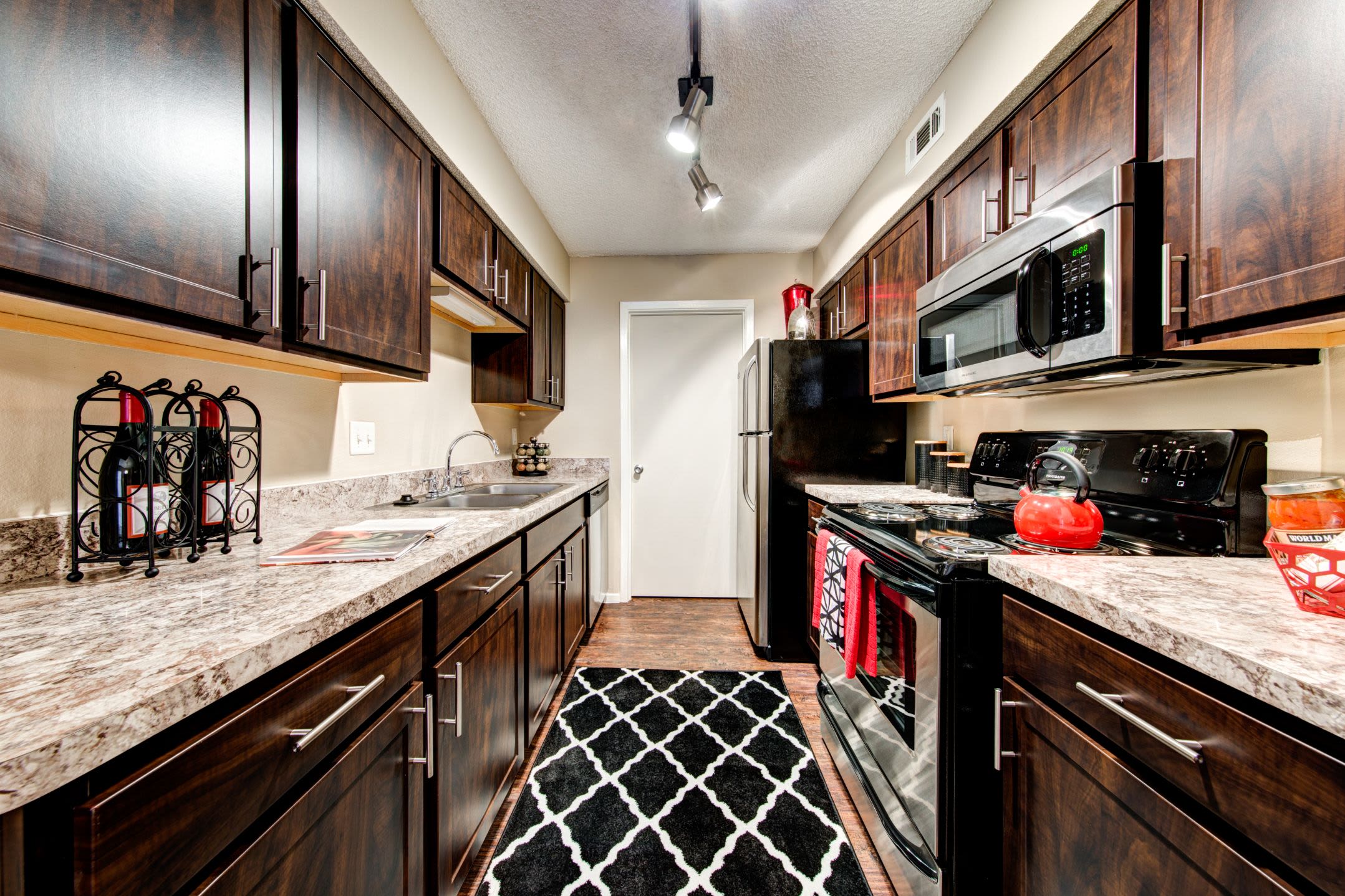 Modern kitchen with dark colored cabinets at The Park at Flower Mound in Flower Mound, Texas