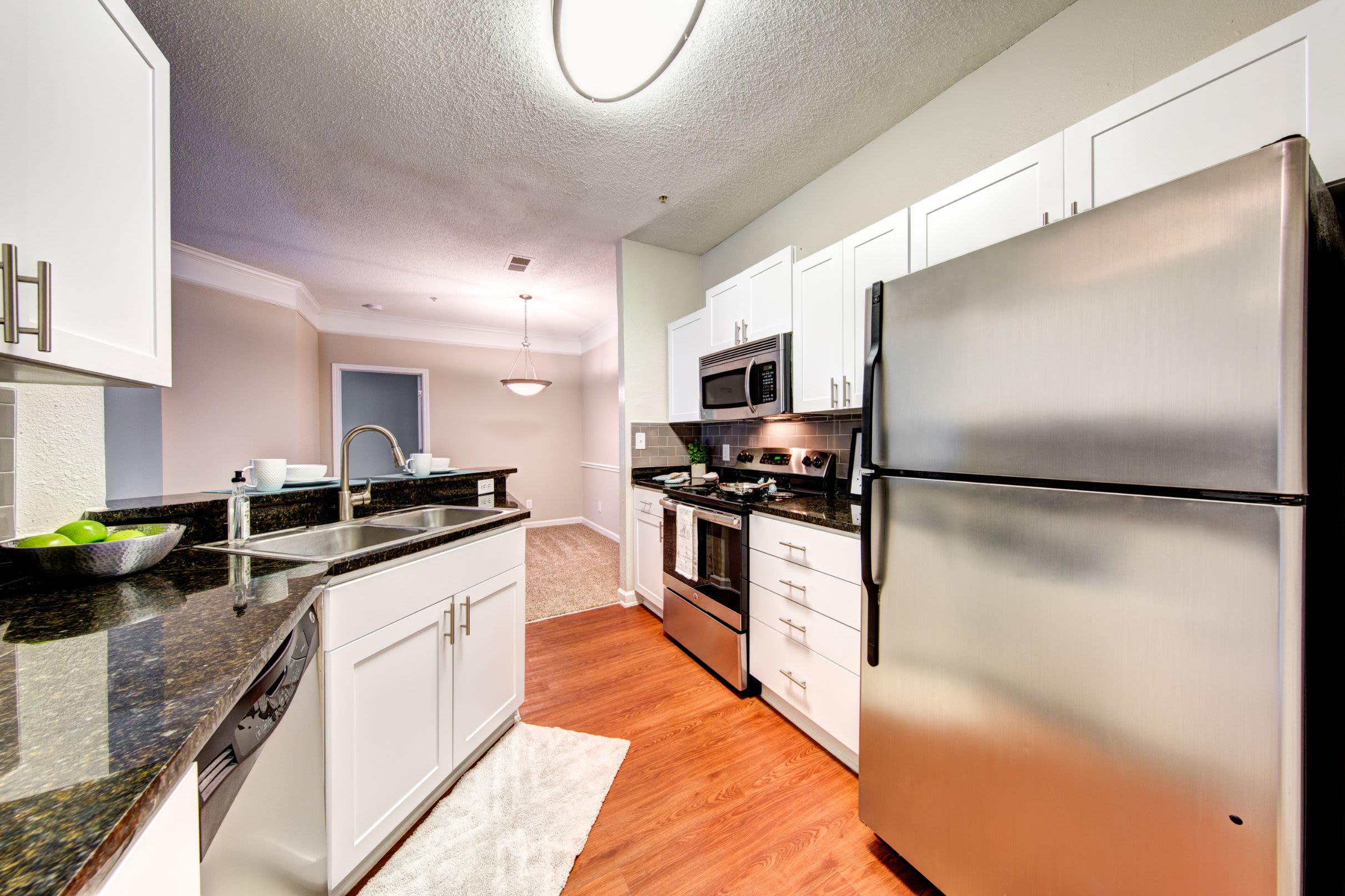 Bright kitchen with a large stainless steel fridge at Marquis on Edwards Mill in Raleigh, North Carolina