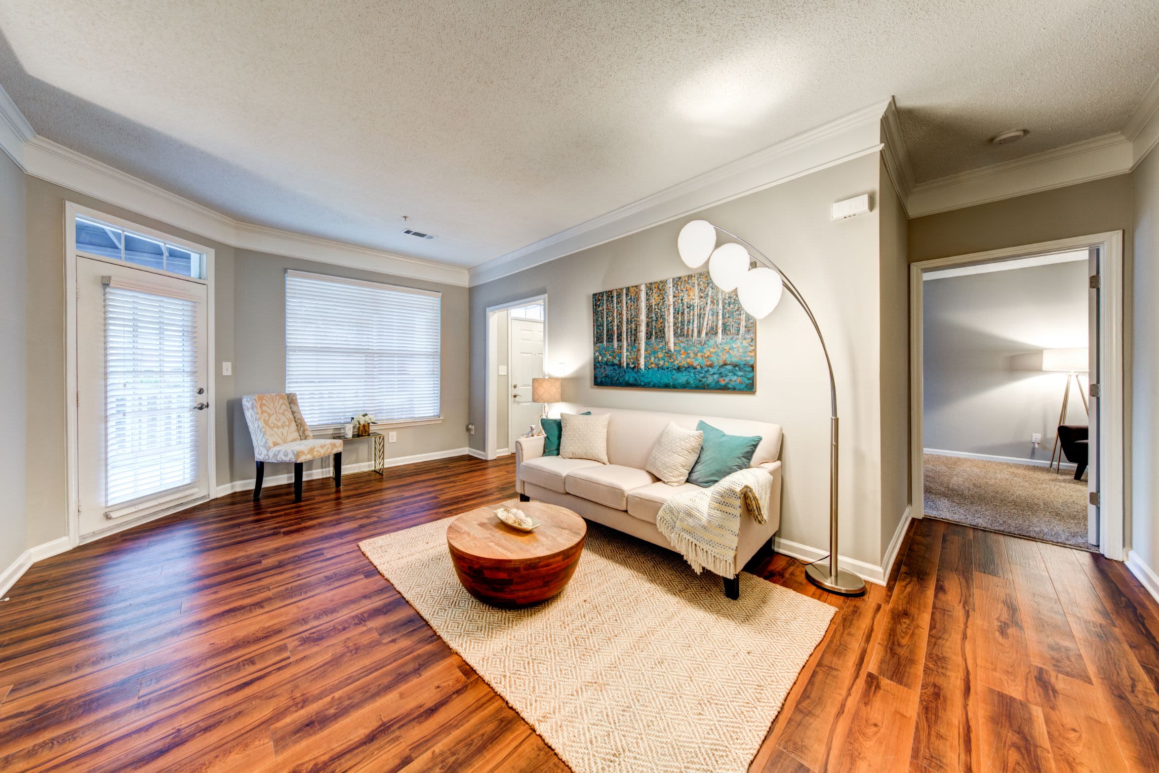 Spacious living area with large windows at Marquis on Edwards Mill in Raleigh, North Carolina