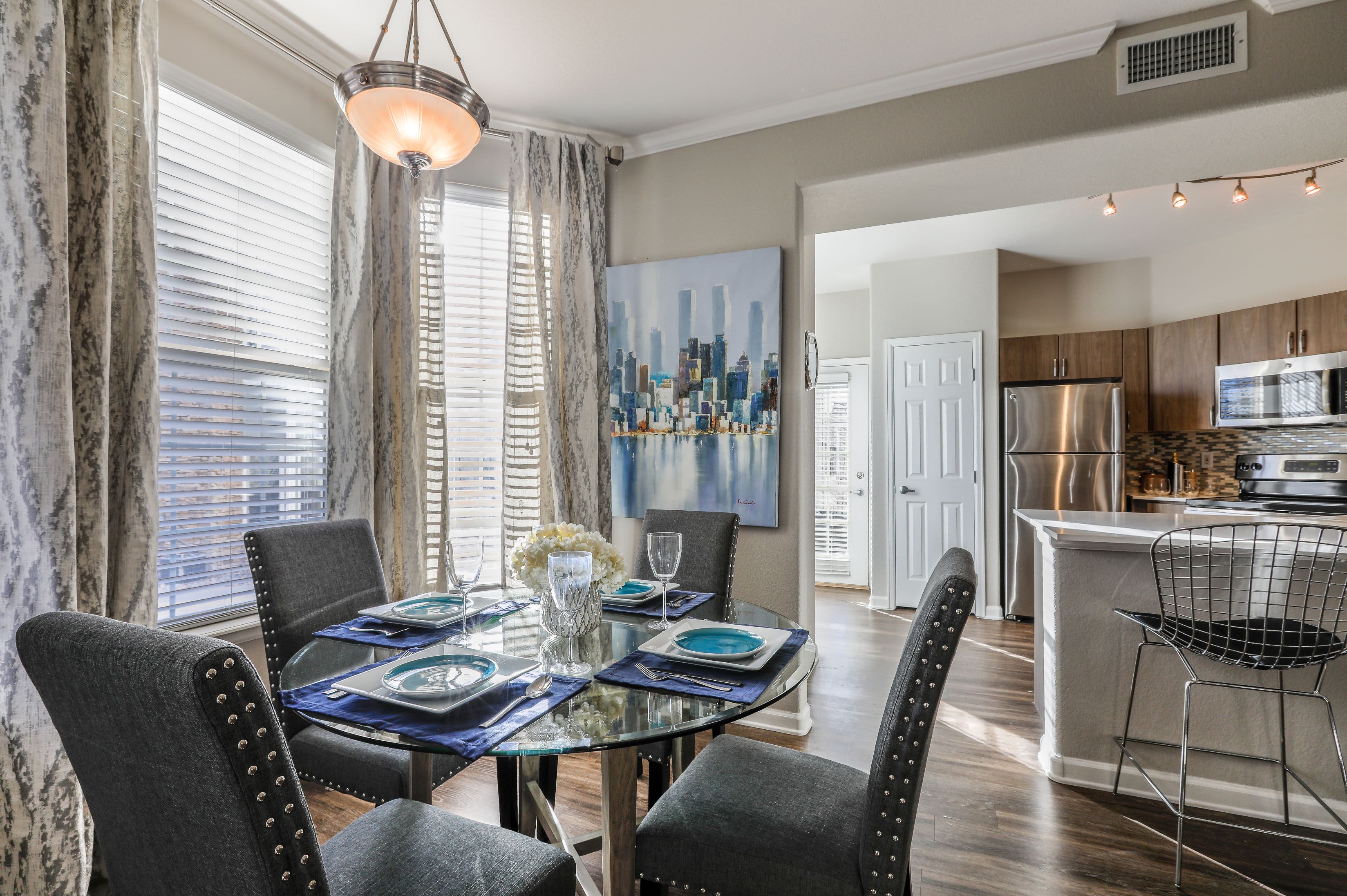 Bright dining area with multiple windows at Marquis Castle Pines in Castle Pines, Colorado