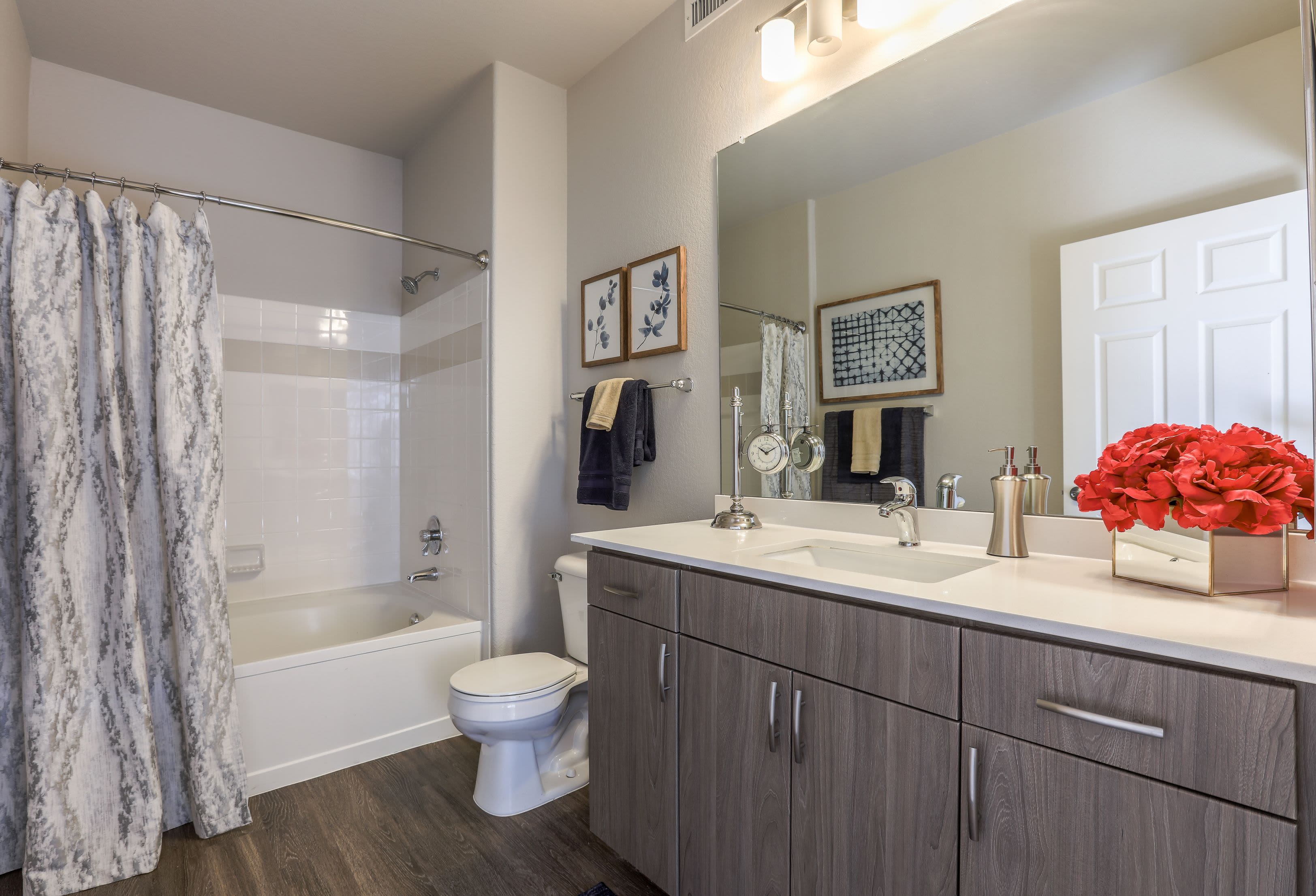 Clean bathroom with wood style floors at Marquis Castle Pines in Castle Pines, Colorado