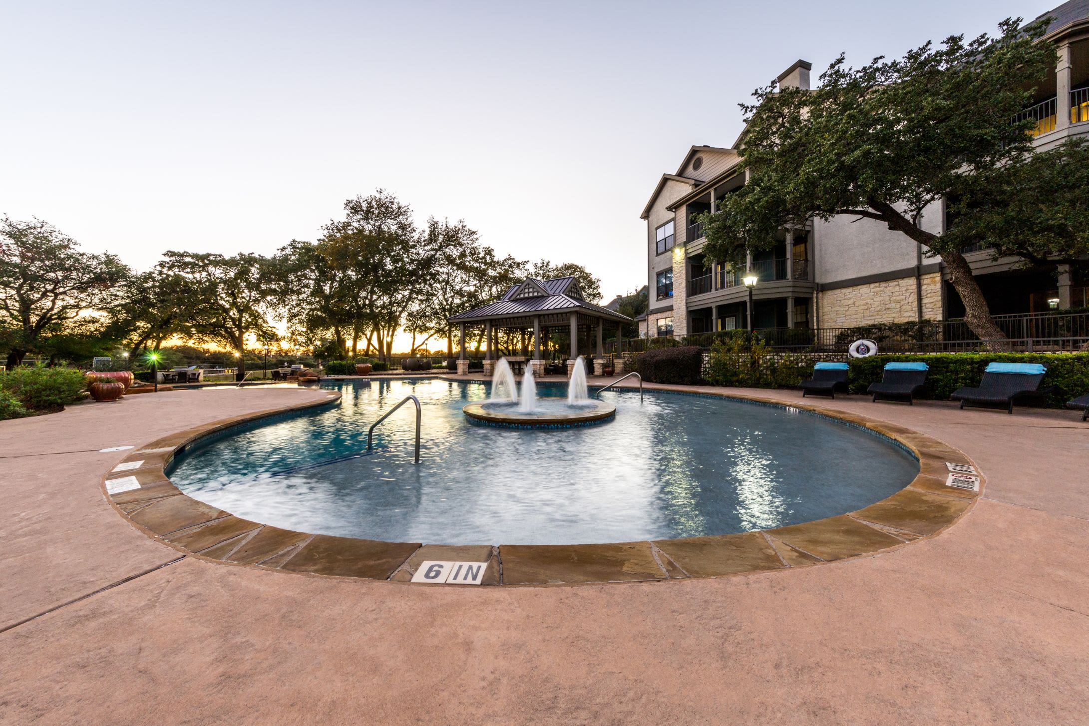 Swimming pool with a fountain in the center at The Marquis at Brushy Creek in Austin, Texas