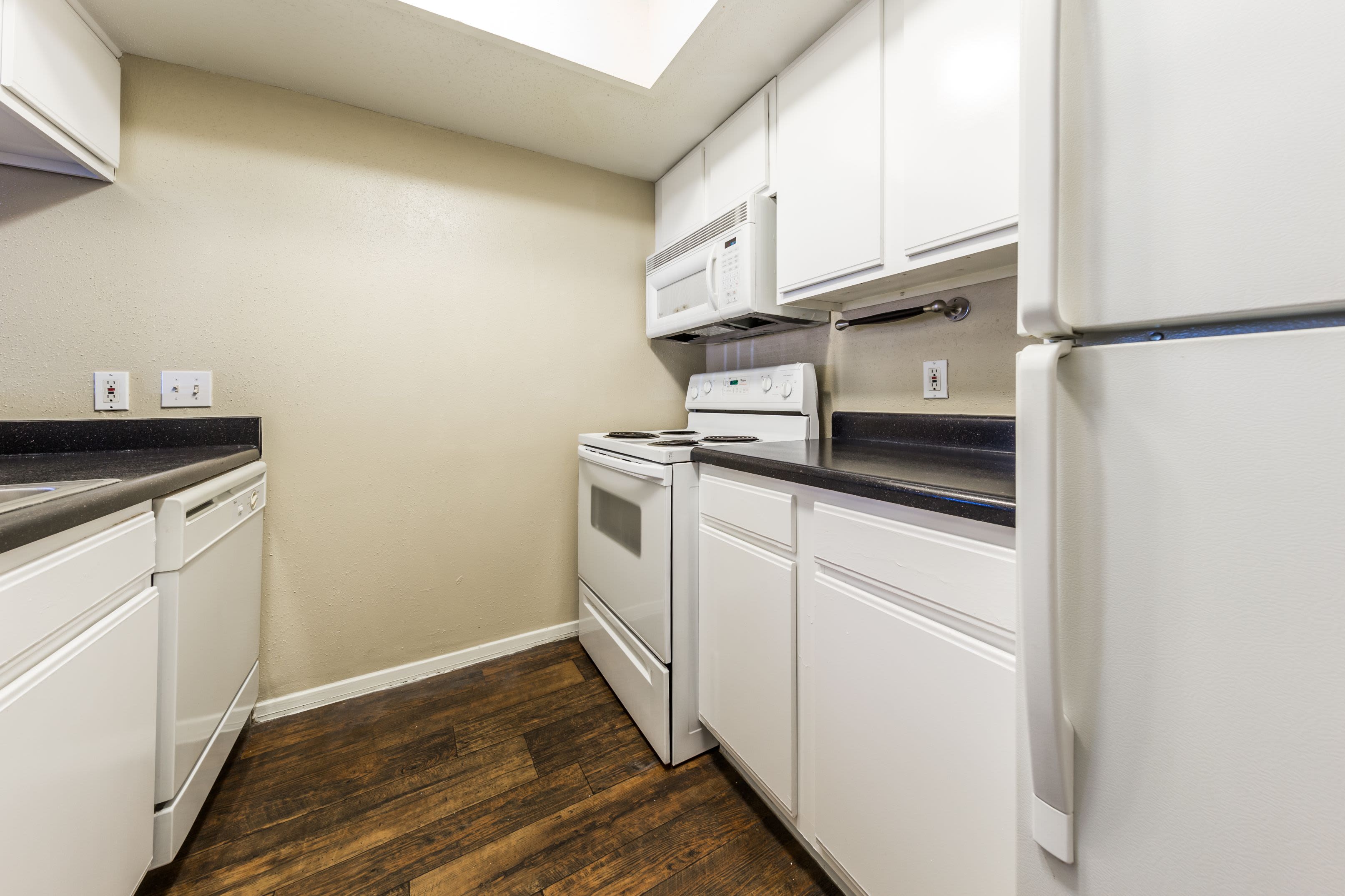 Kitchen with white appliances at SoCo on The Lake in Austin, Texas