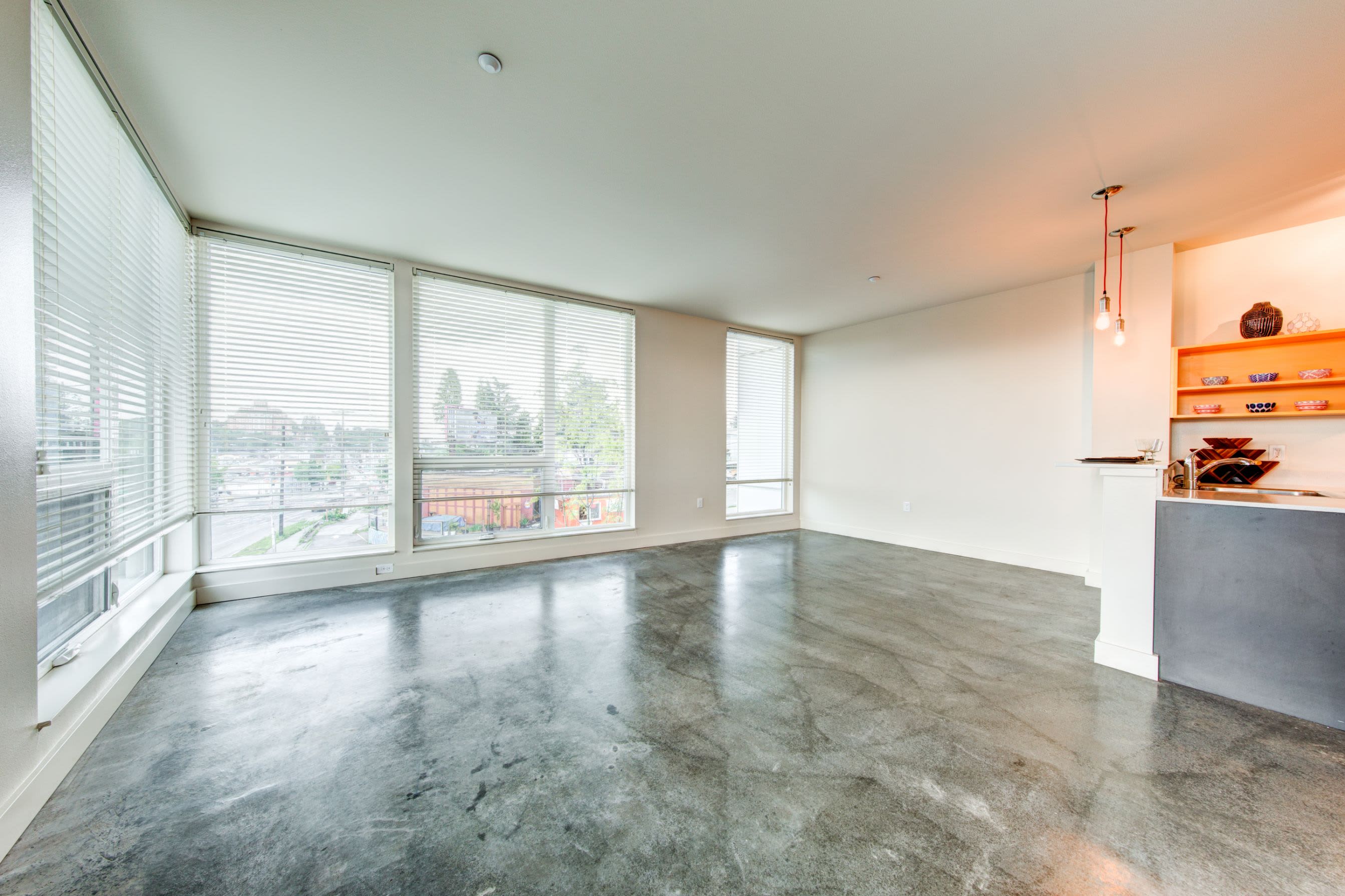 Bright living room with massive floor to ceiling windows at Anthem on 12th in Seattle, Washington
