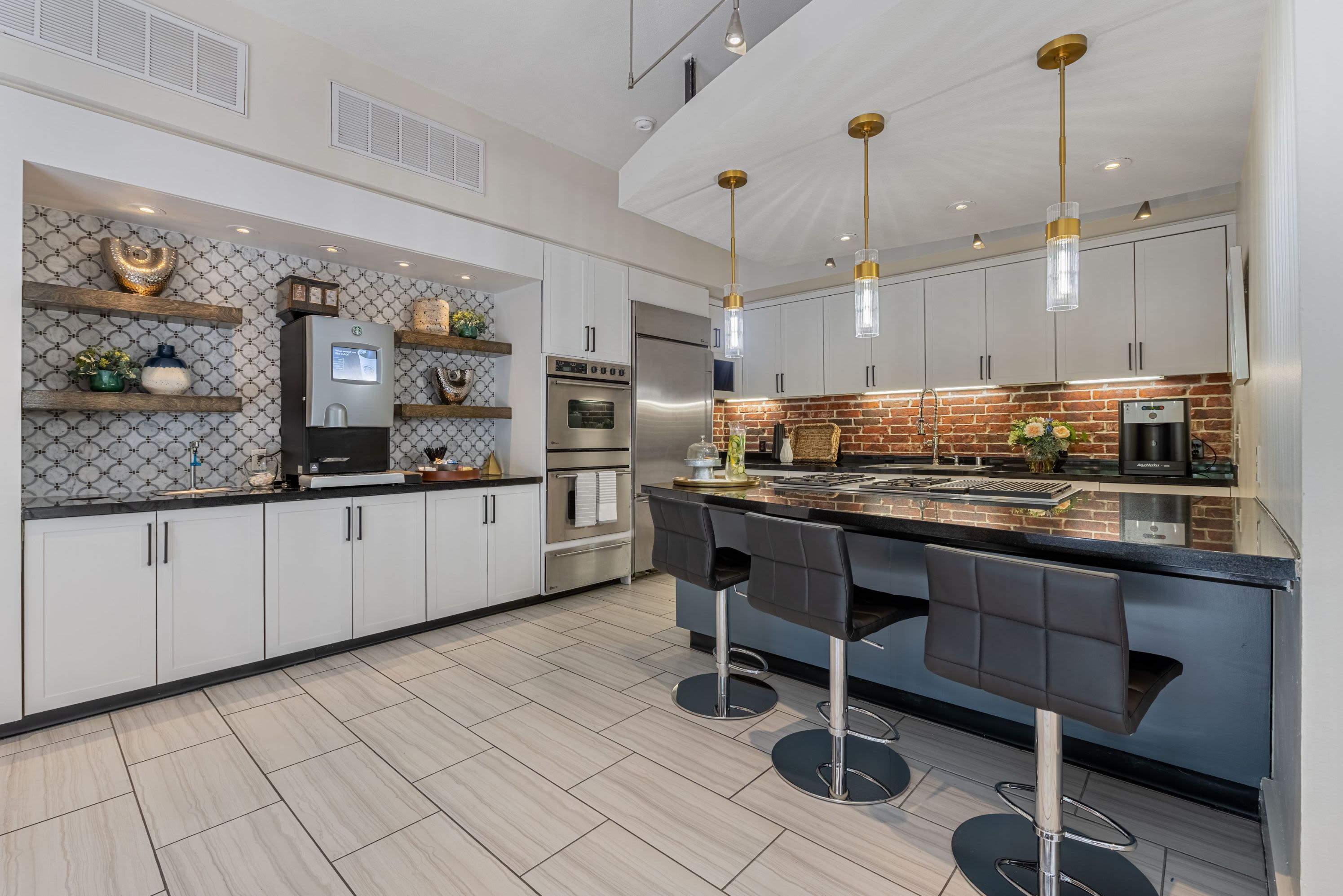 Kitchen with a breakfast bar in the clubhouse at Marquis Lofts on Sabine in Houston, Texas