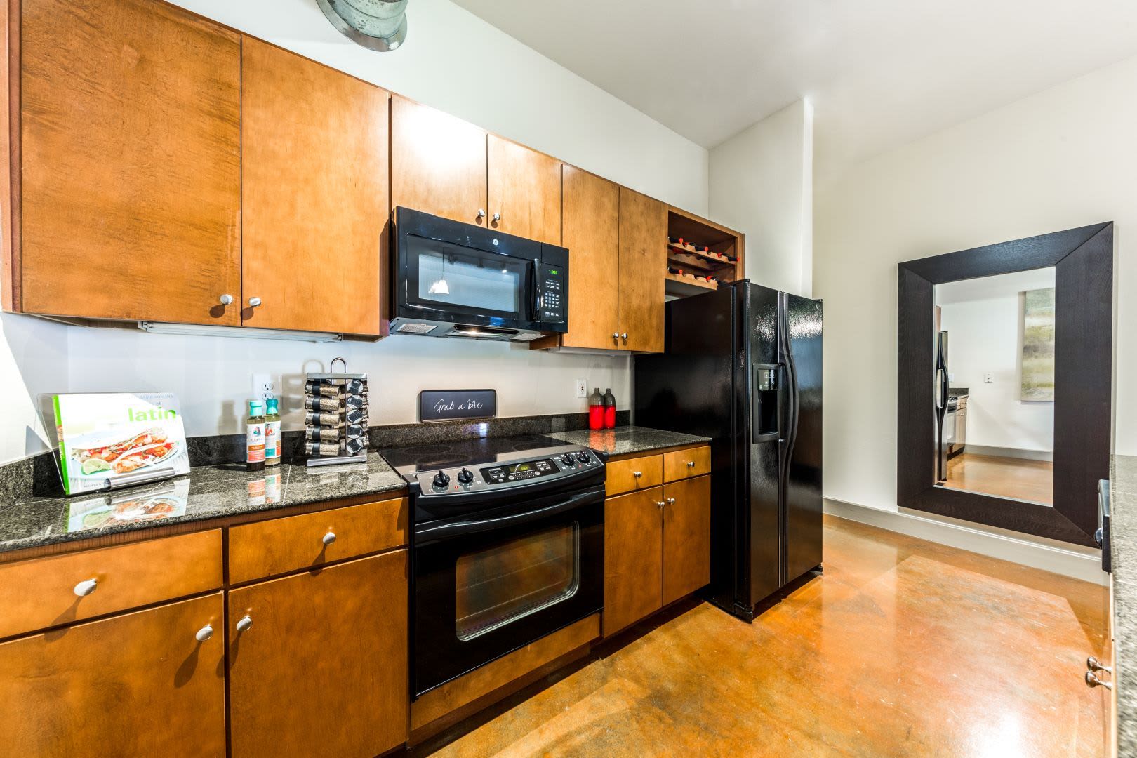 Kitchen with black appliances at Marquis Lofts on Sabine in Houston, Texas