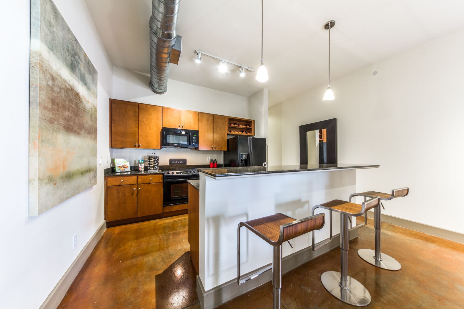 Kitchen with a breakfast bar at Marquis Lofts on Sabine in Houston, Texas