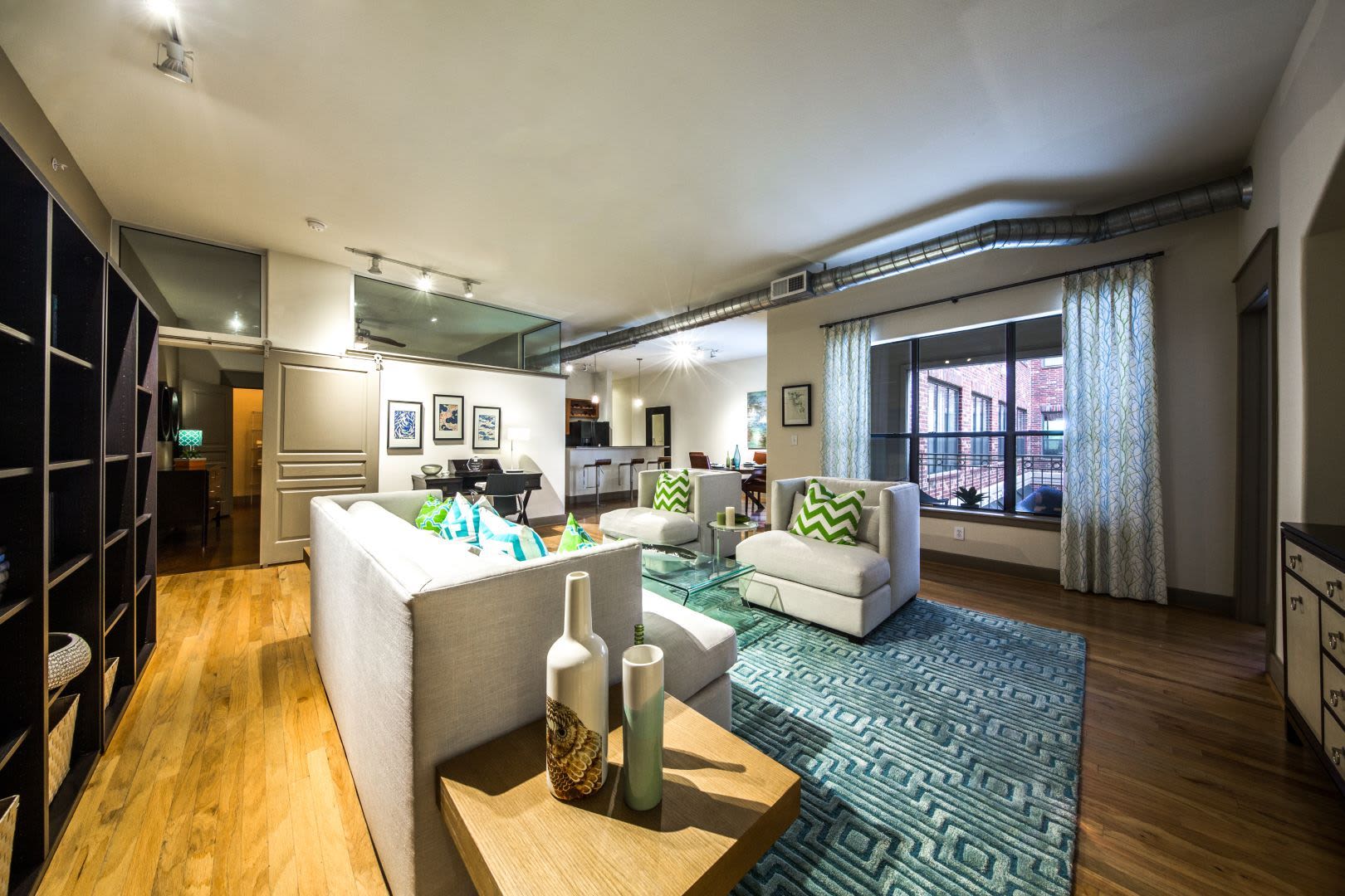 Spacious living area with a large rug at Marquis Lofts on Sabine in Houston, Texas