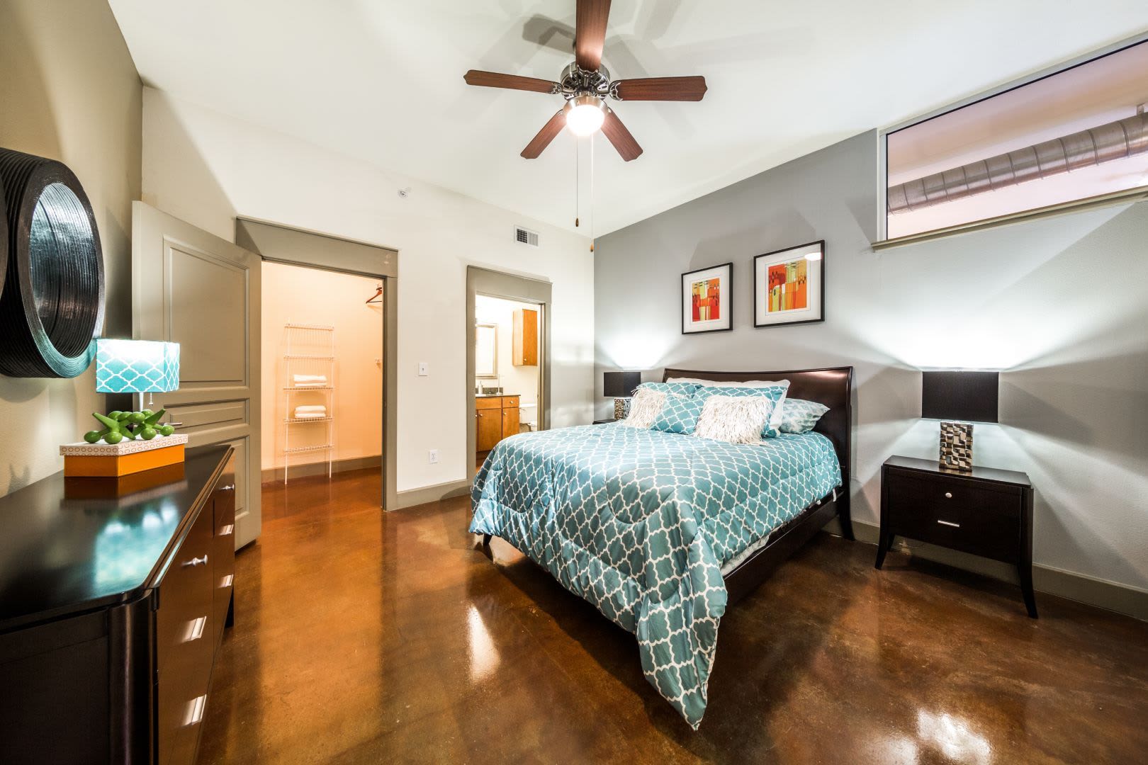 Well decorated bedroom with an accent wall at Marquis Lofts on Sabine in Houston, Texas