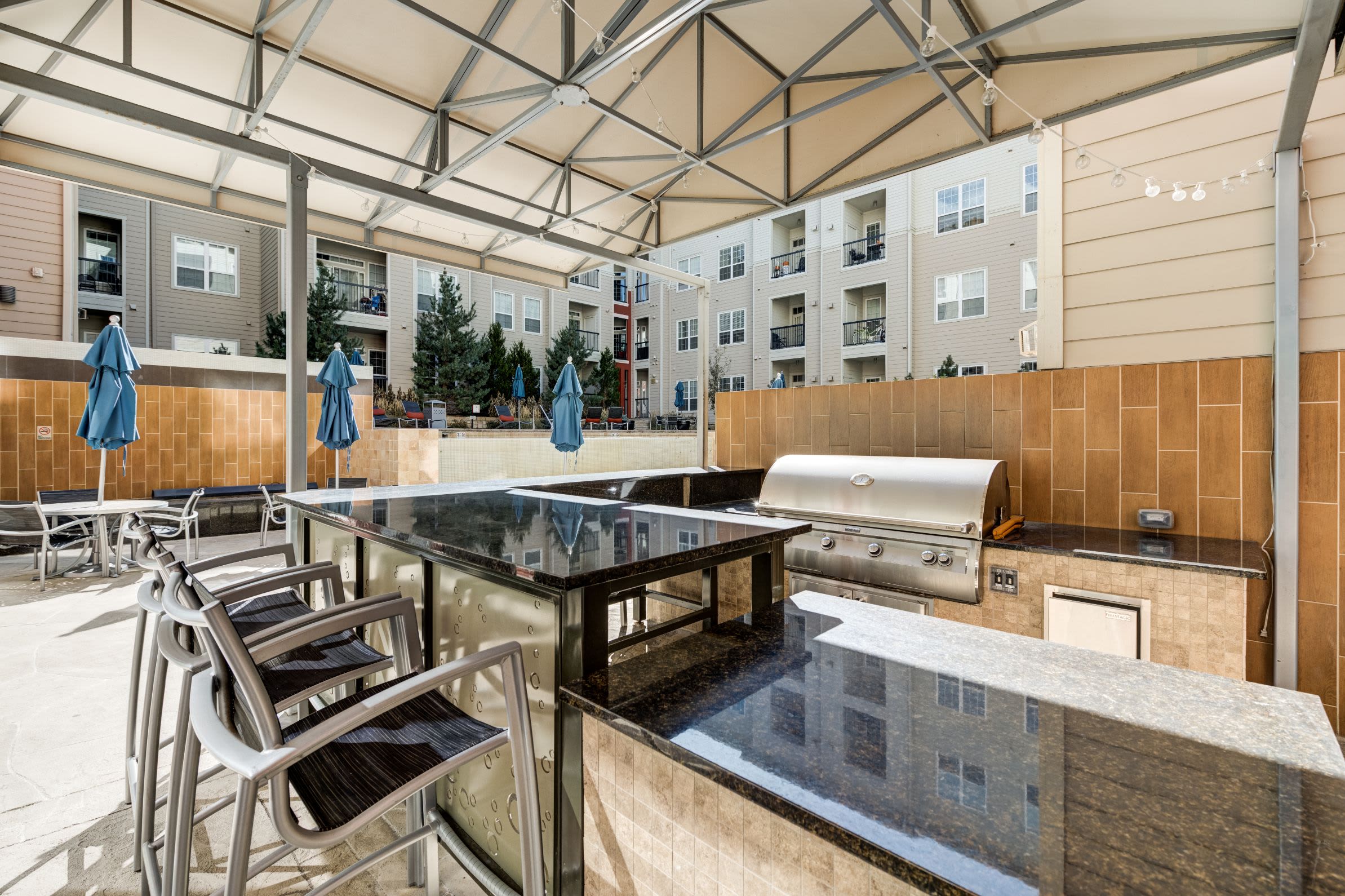 Outdoor community lounge with grills at The Marq at Ridgegate in Lone Tree, Colorado