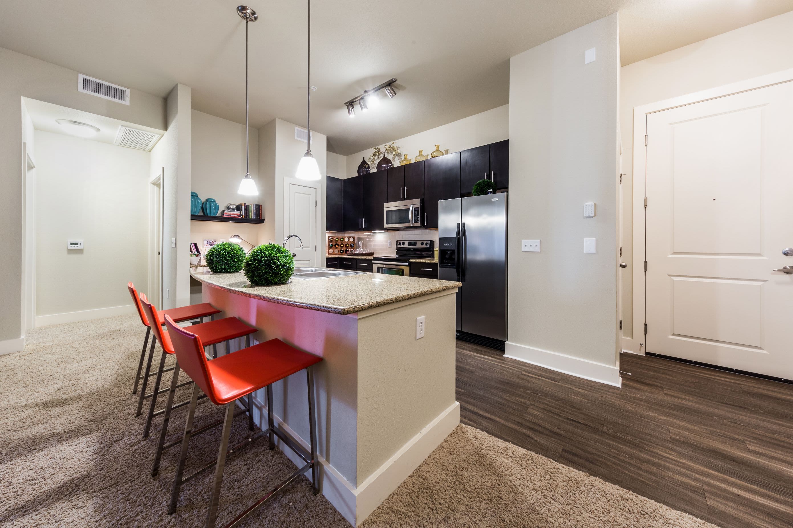 Modern kitchen with a breakfast bar at The Marq at Ridgegate in Lone Tree, Colorado