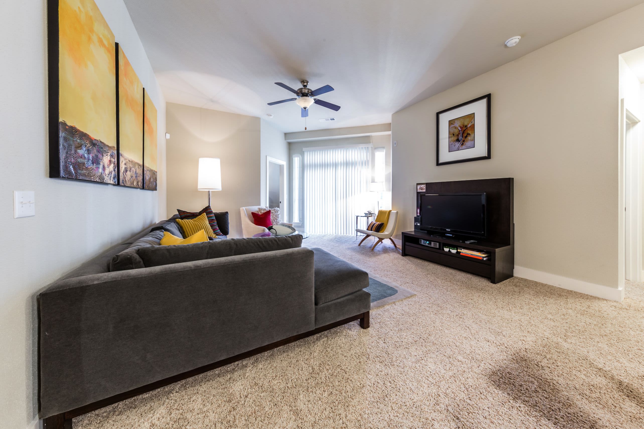 Bright living room with a large window at The Marq at Ridgegate in Lone Tree, Colorado