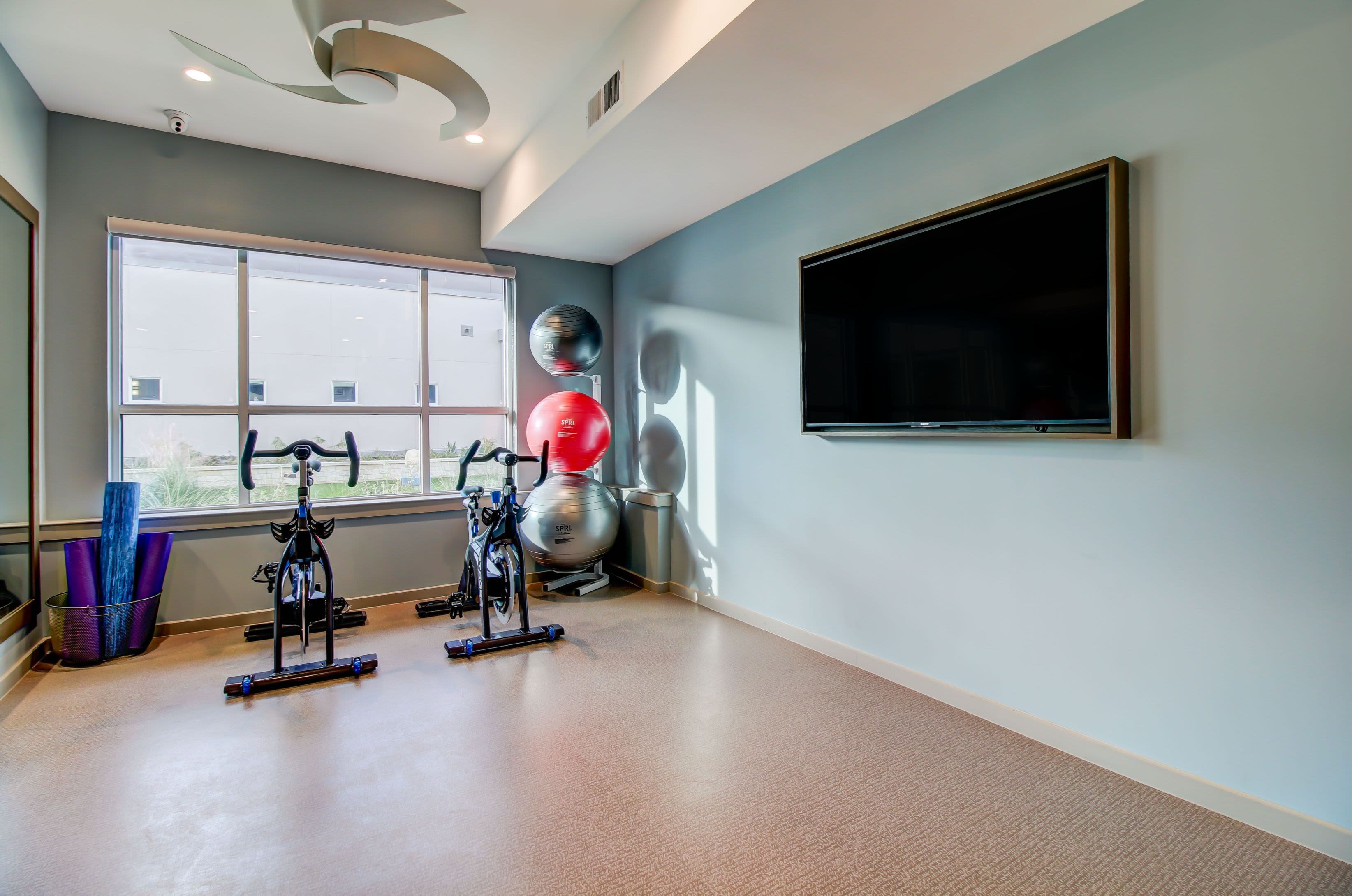 Spin cycle room with a large TV at Westerly 360 in Austin, Texas