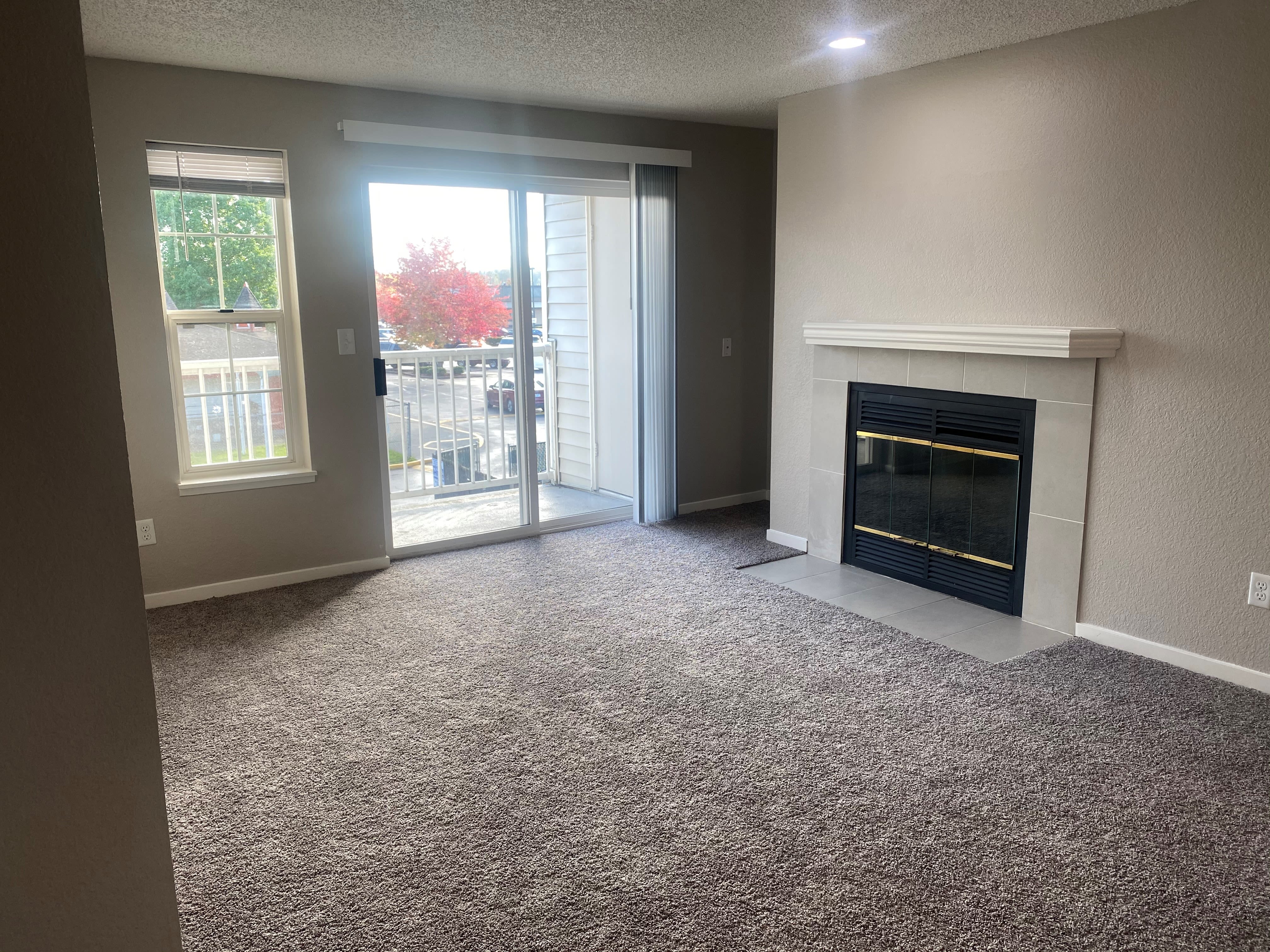 Bright living area with a fireplace at Autumn Chase in Bothell, Washington