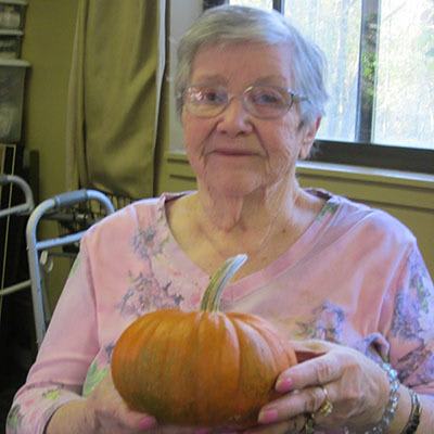 Woman with a pumpkin at The Ridge at Madison in Fitchburg, Wisconsin