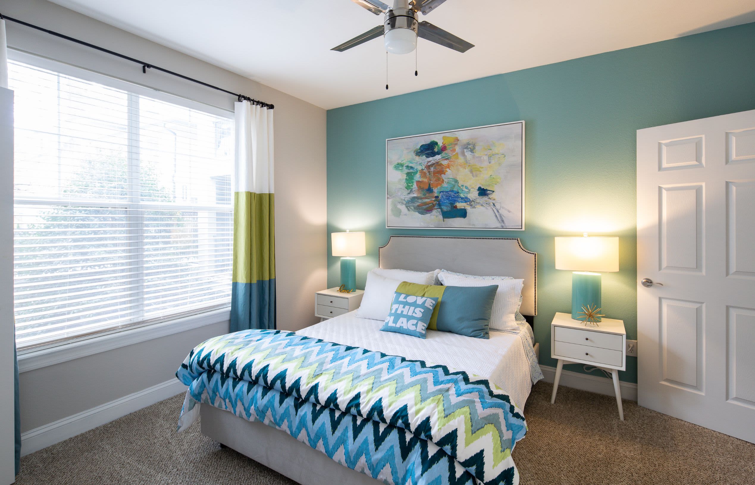 Spacious bedroom with large windows and a ceiling fan at Marq Perimeter in Atlanta, Georgia