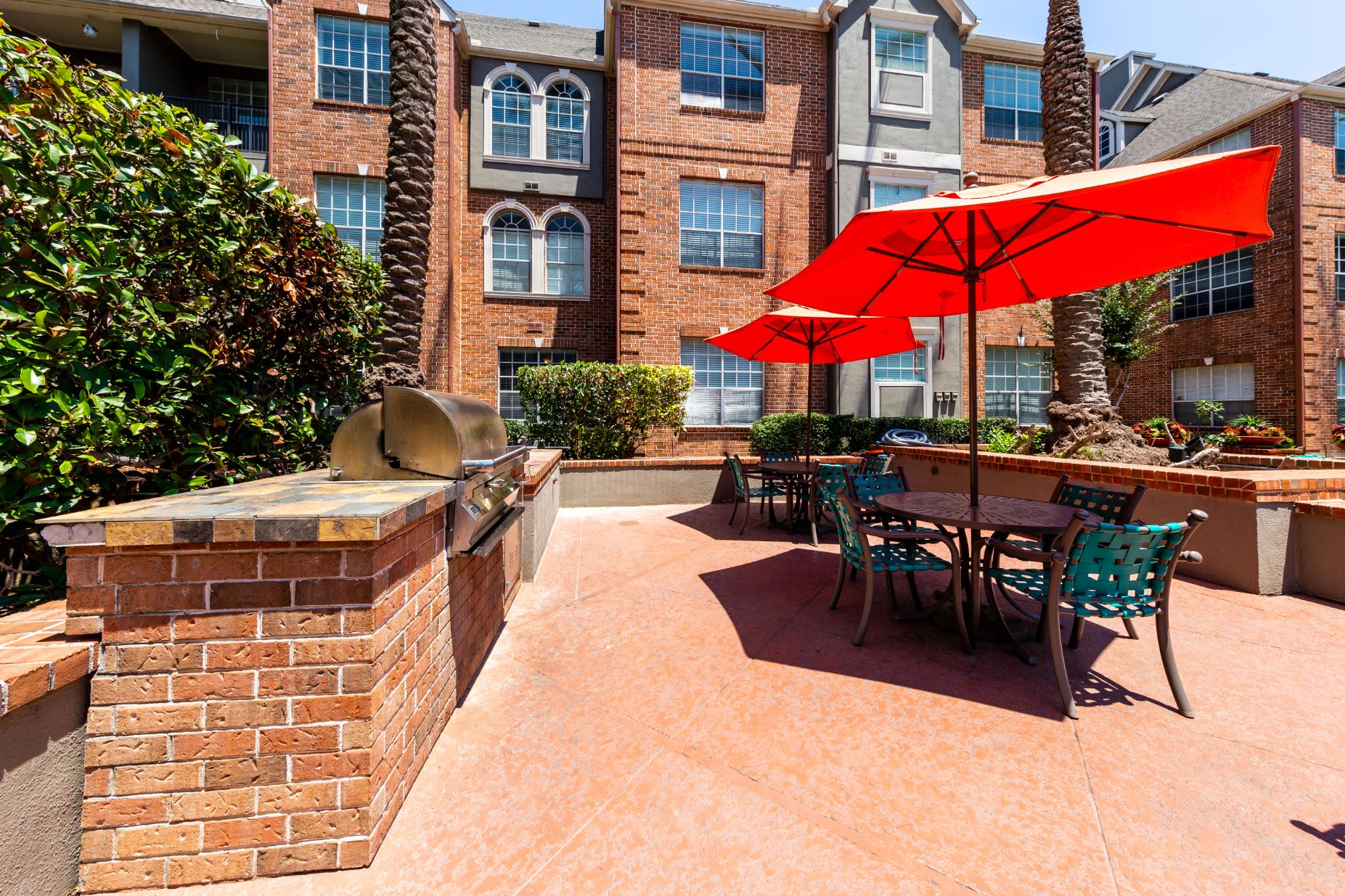 Patio with seating and gas grills at Marquis on Pin Oak in Houston, Texas
