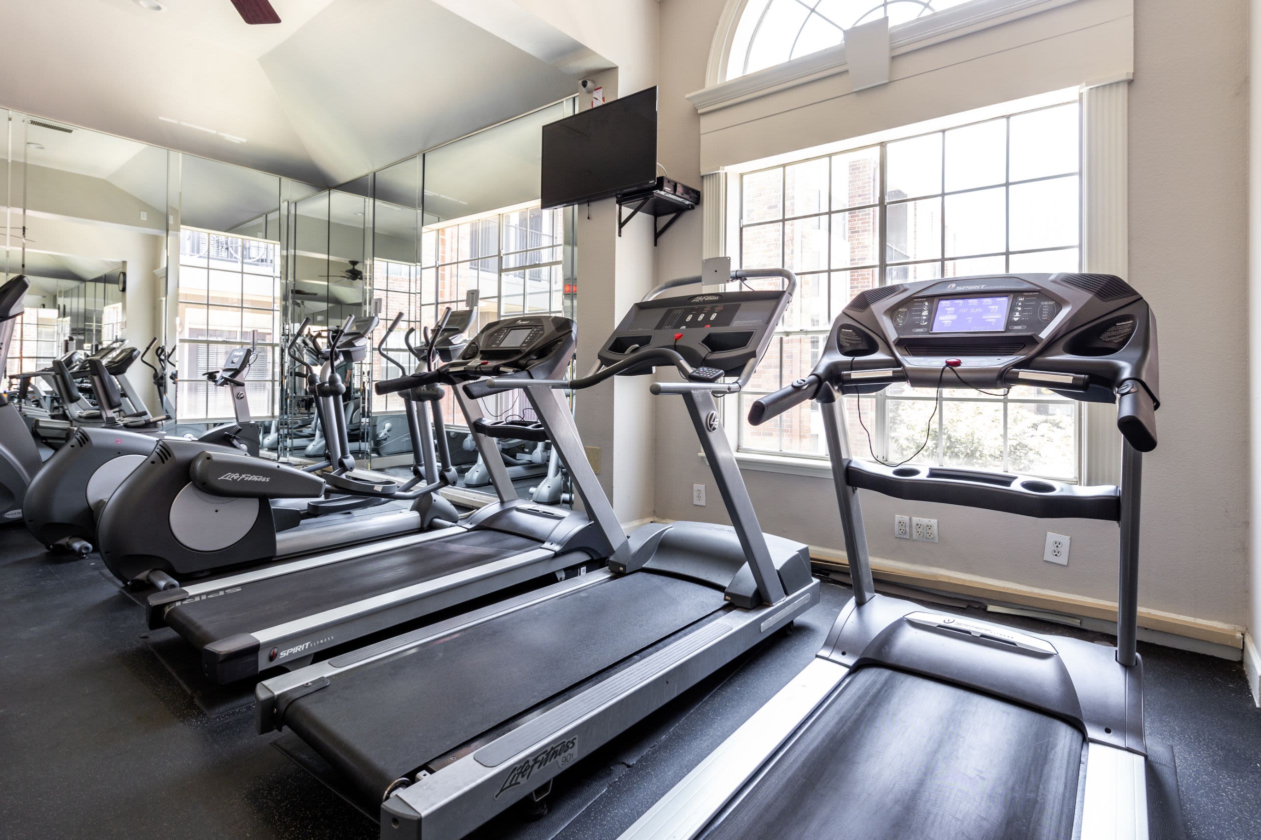 Row of cardio machines in the fitness center at Marquis on Pin Oak in Houston, Texas