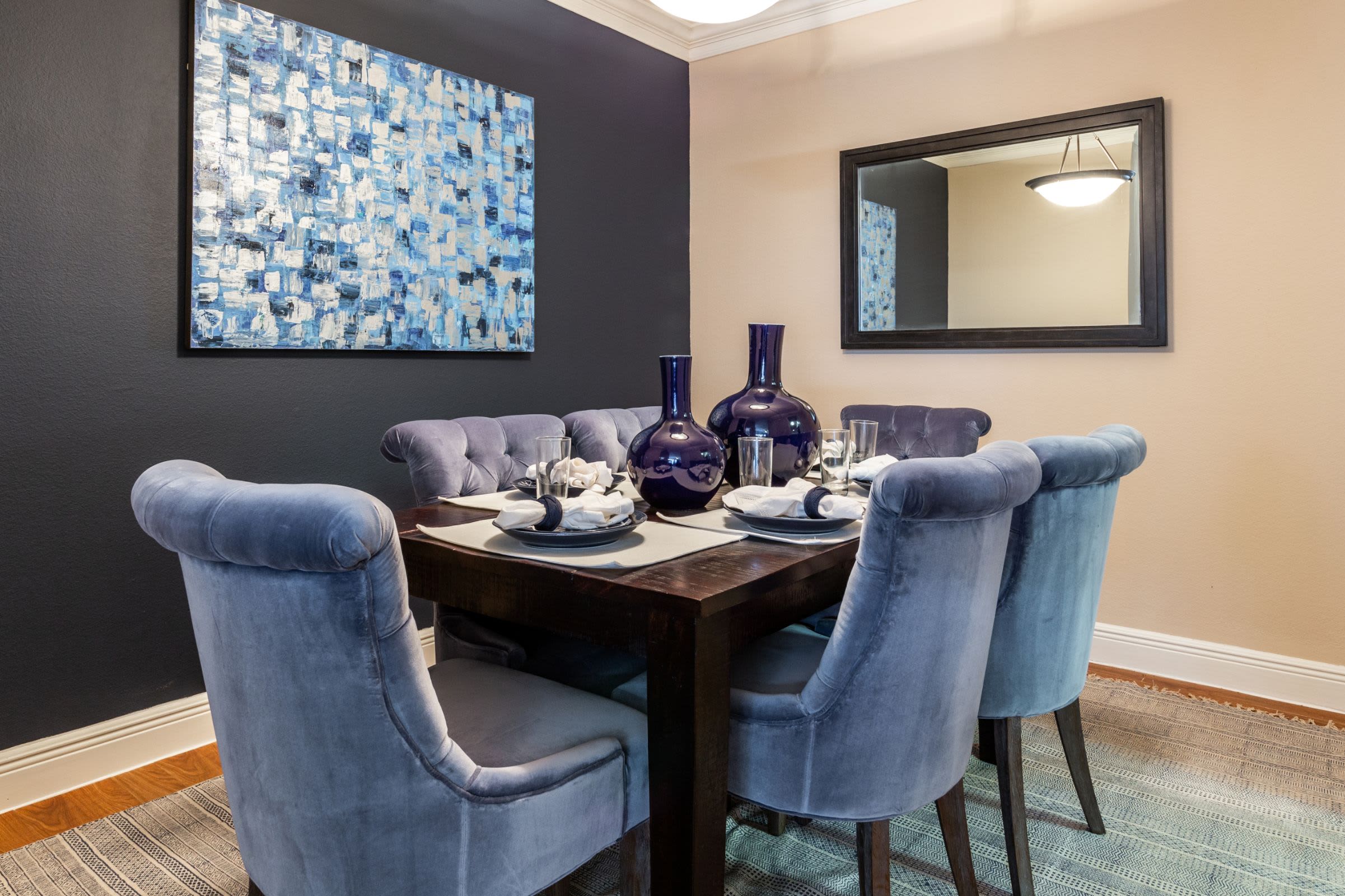 Dining room with a navy colored accent wall at Marquis on Pin Oak in Houston, Texas