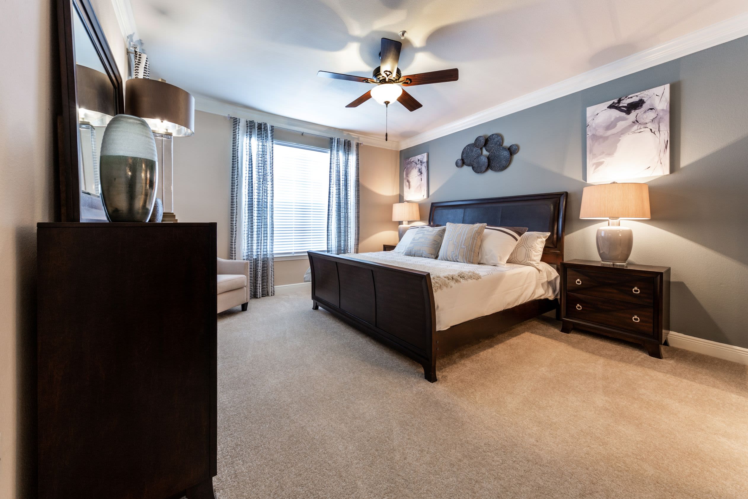 Bright bedroom with a ceiling fan at Marquis on Pin Oak in Houston, Texas