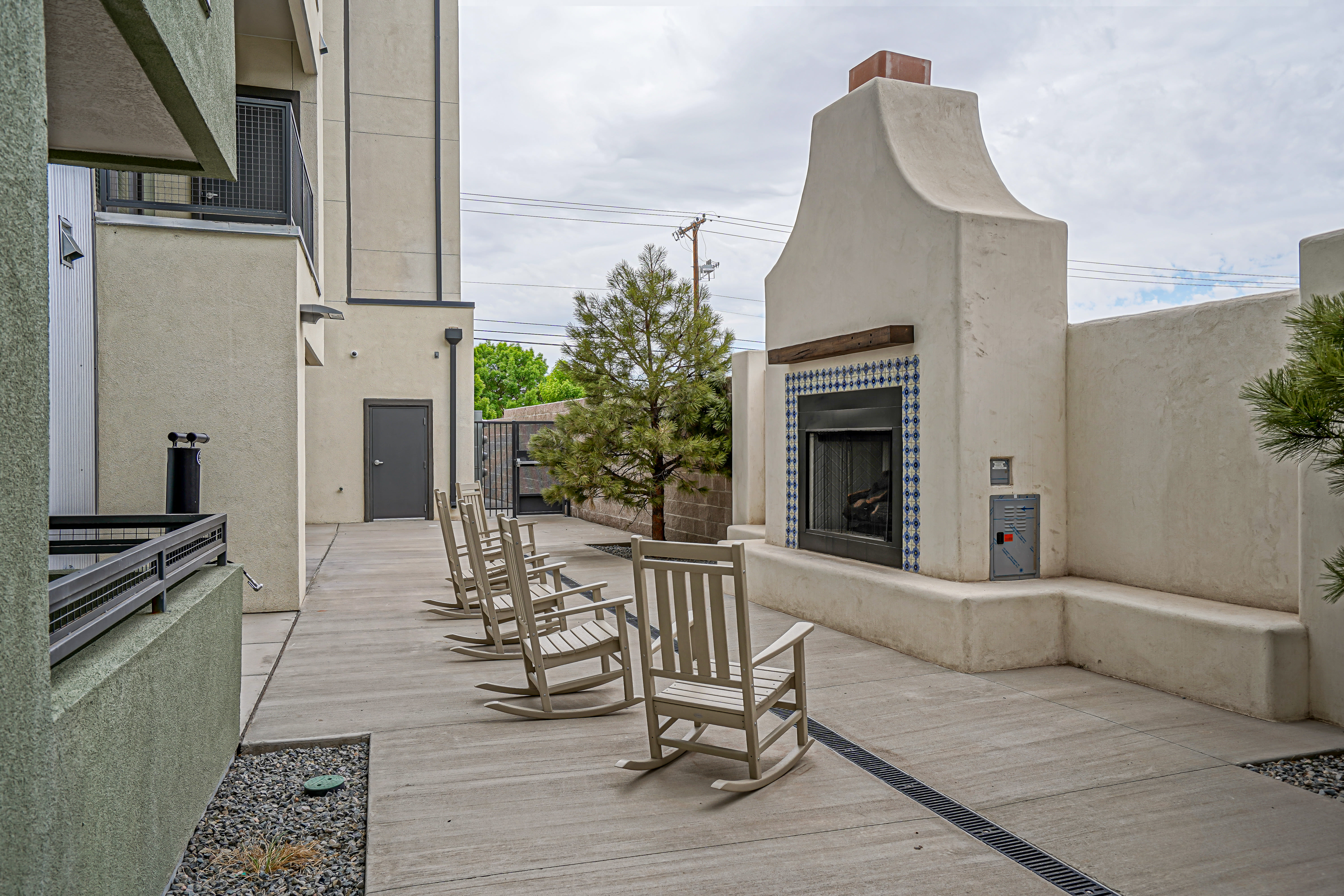 Outdoor patio seating with a fireplace at Capitol Flats in Santa Fe, New Mexico