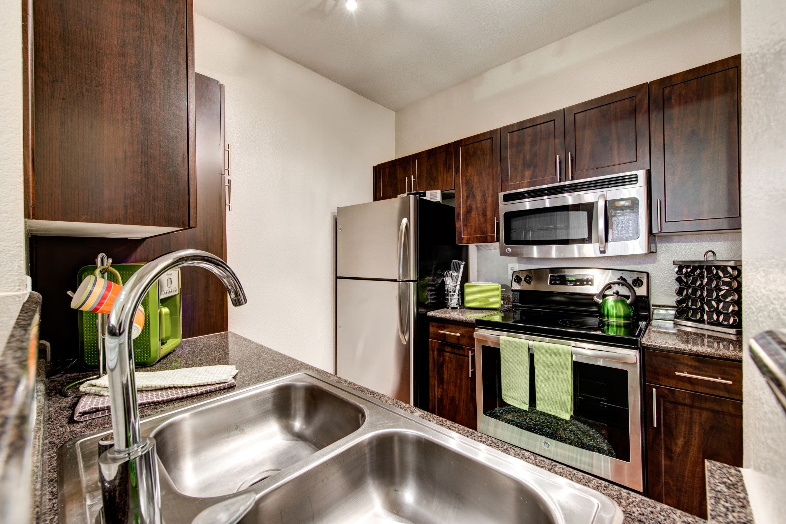 Kitchen with dark brown cabinets at Marquis on Gaston in Dallas, Texas
