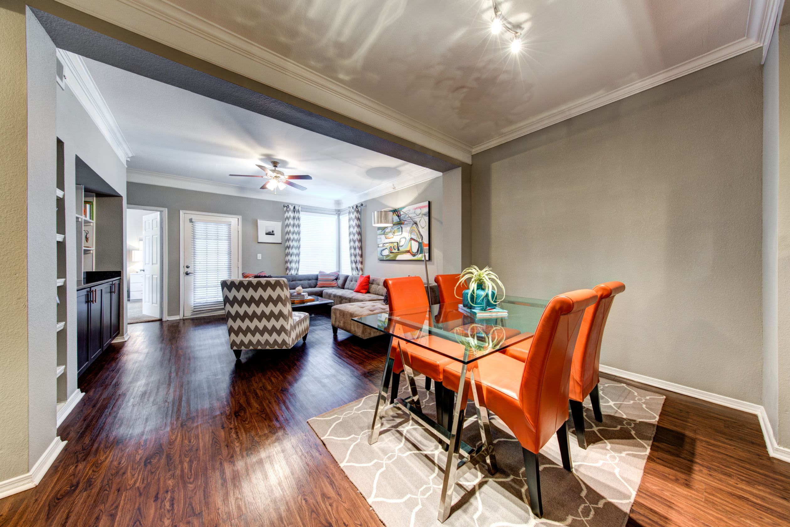 Dining room with wood floors and a rug under the table at Marquis on Gaston in Dallas, Texas
