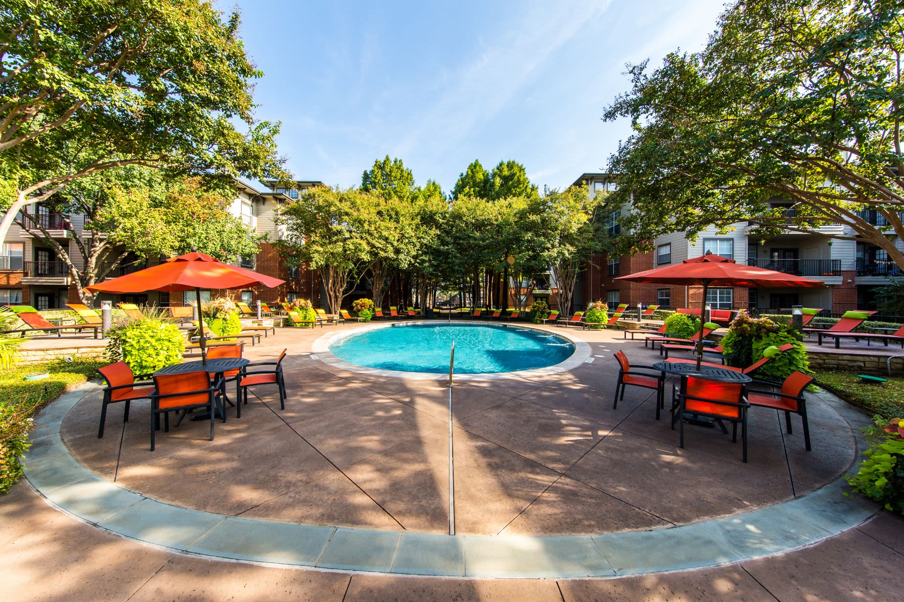 Sparkling pool surrounded by a red brick deck at Marquis on Gaston in Dallas, Texas