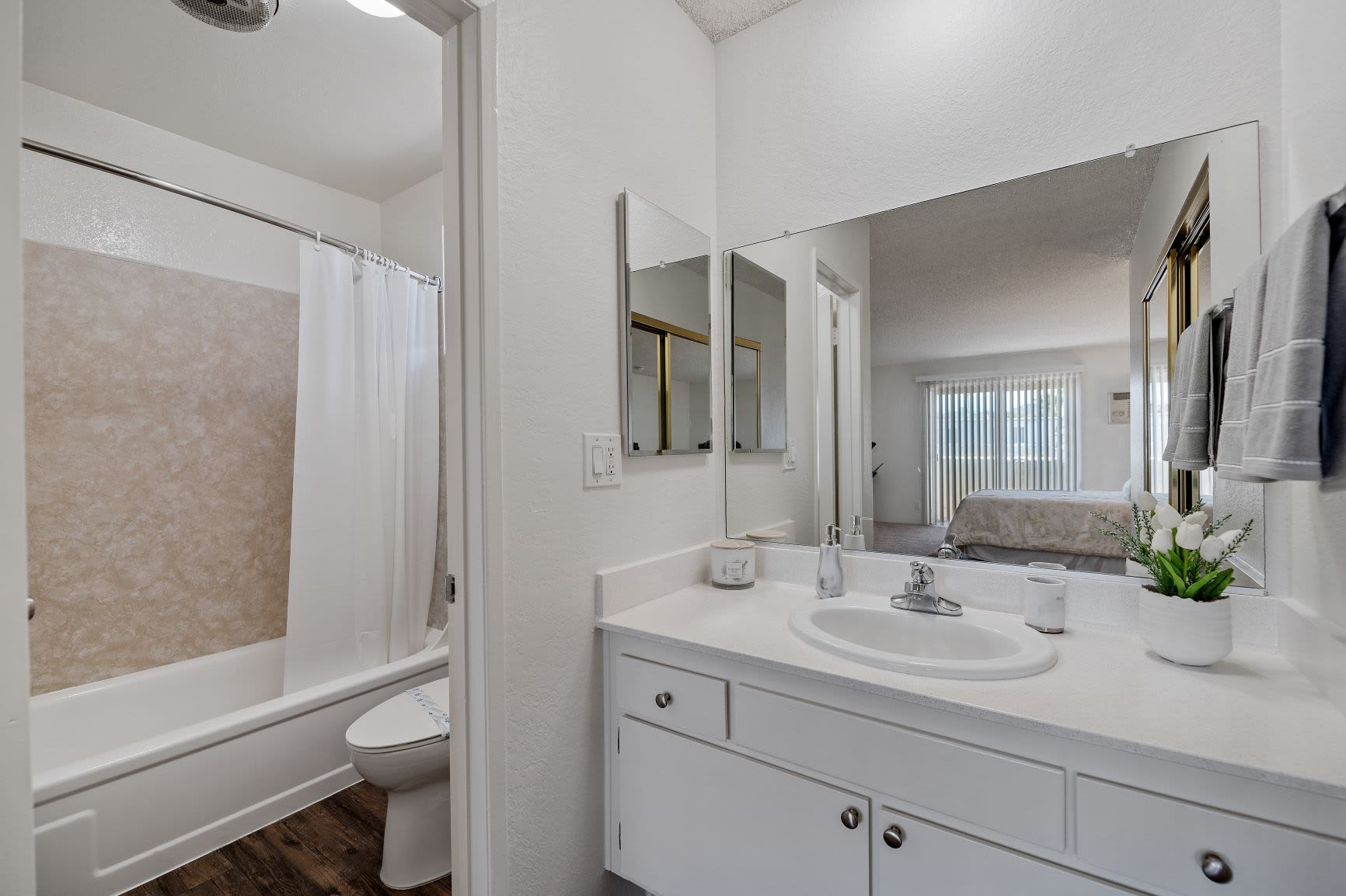 Bathroom with large vanity and bathtub at The Newporter in Tarzana, California
