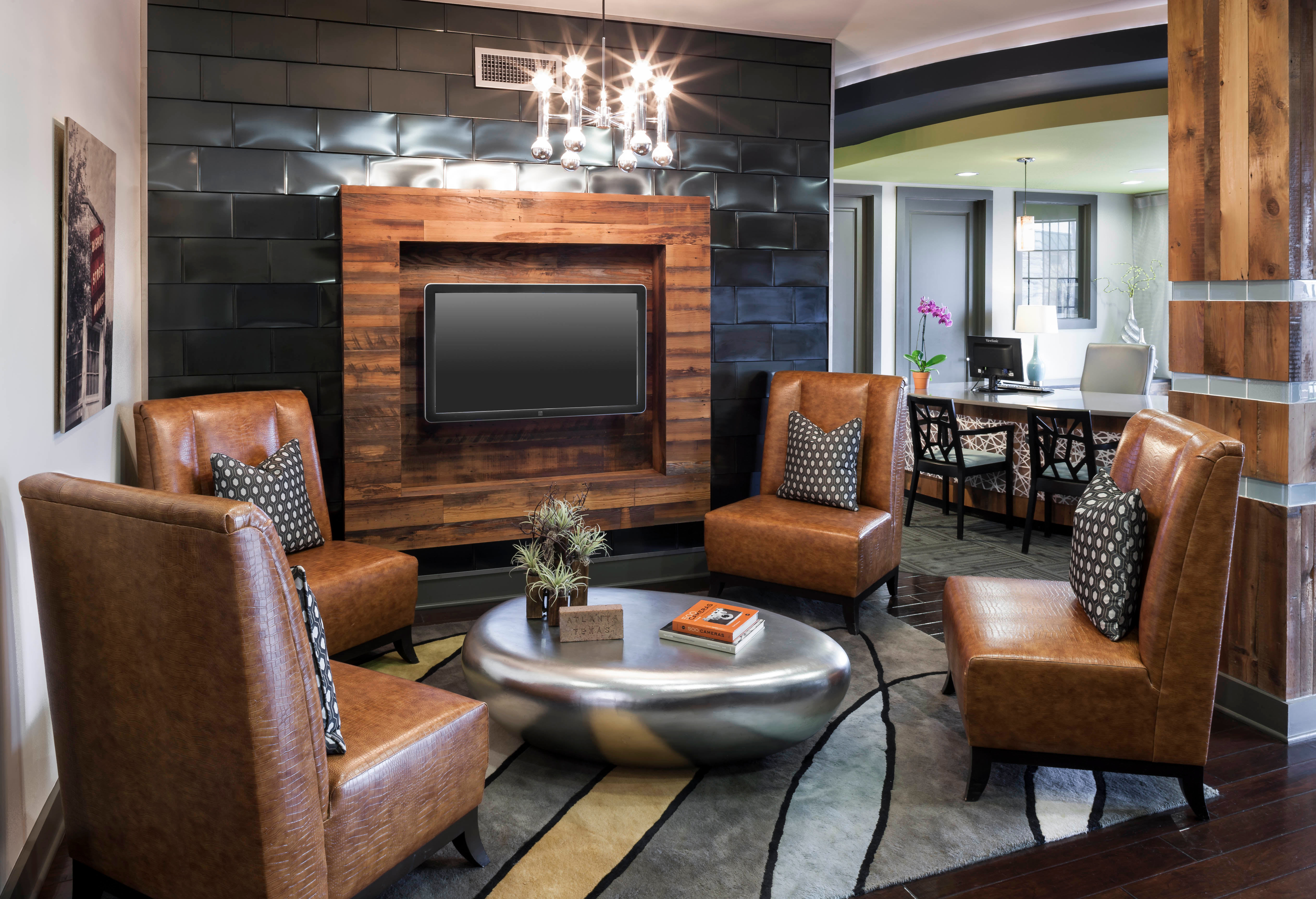 Modern community lounge with leather seating at Bellrock Bishop Arts in Dallas, Texas