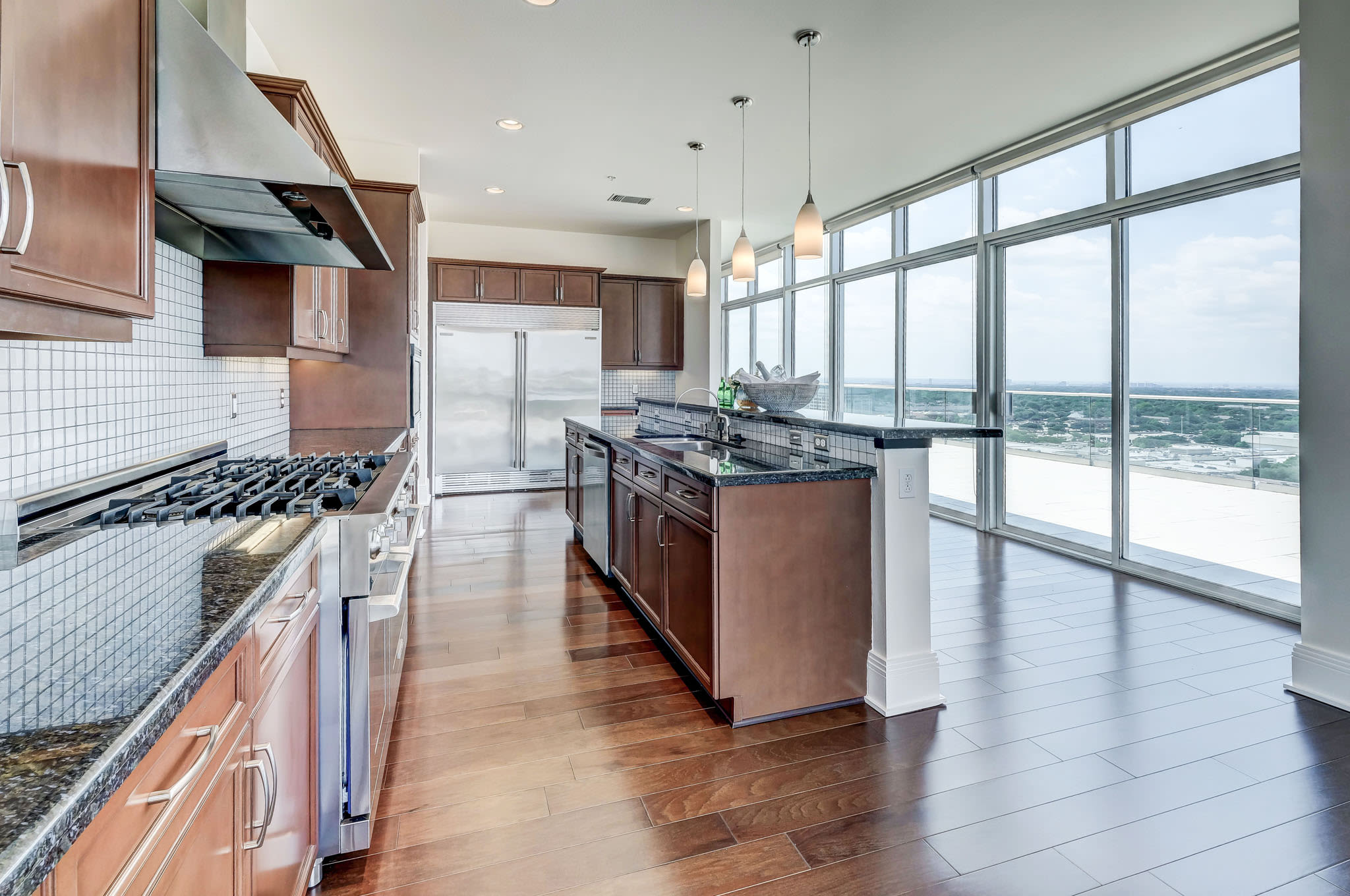 Sleek kitchen with stainless steel appliances at The Heights at Park Lane in Dallas, Texas