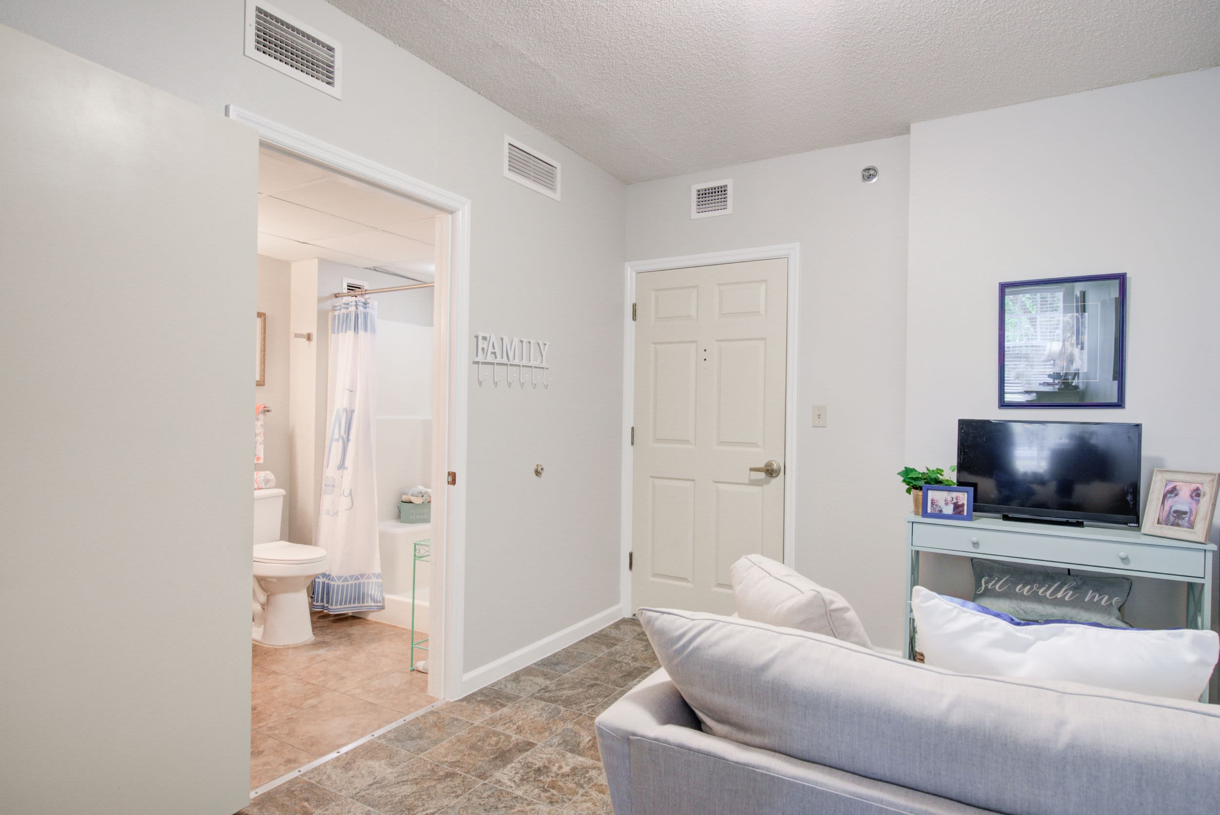 living room connected to bathroom at Truewood by Merrill, Venice in Venice, FL