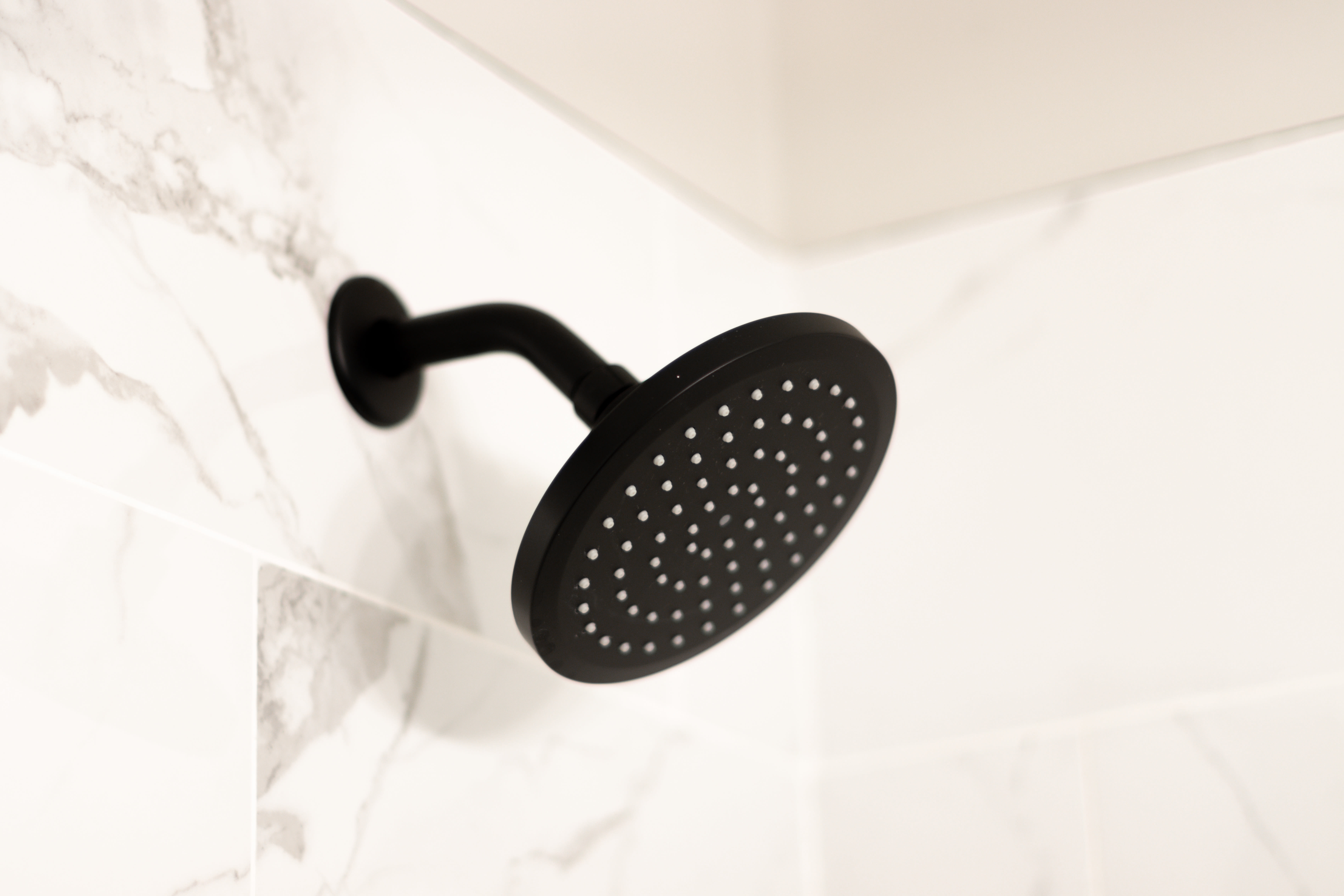 close-up of shower head in bathroom at Flats of Forestville Apartment Homes in Forestville, Maryland