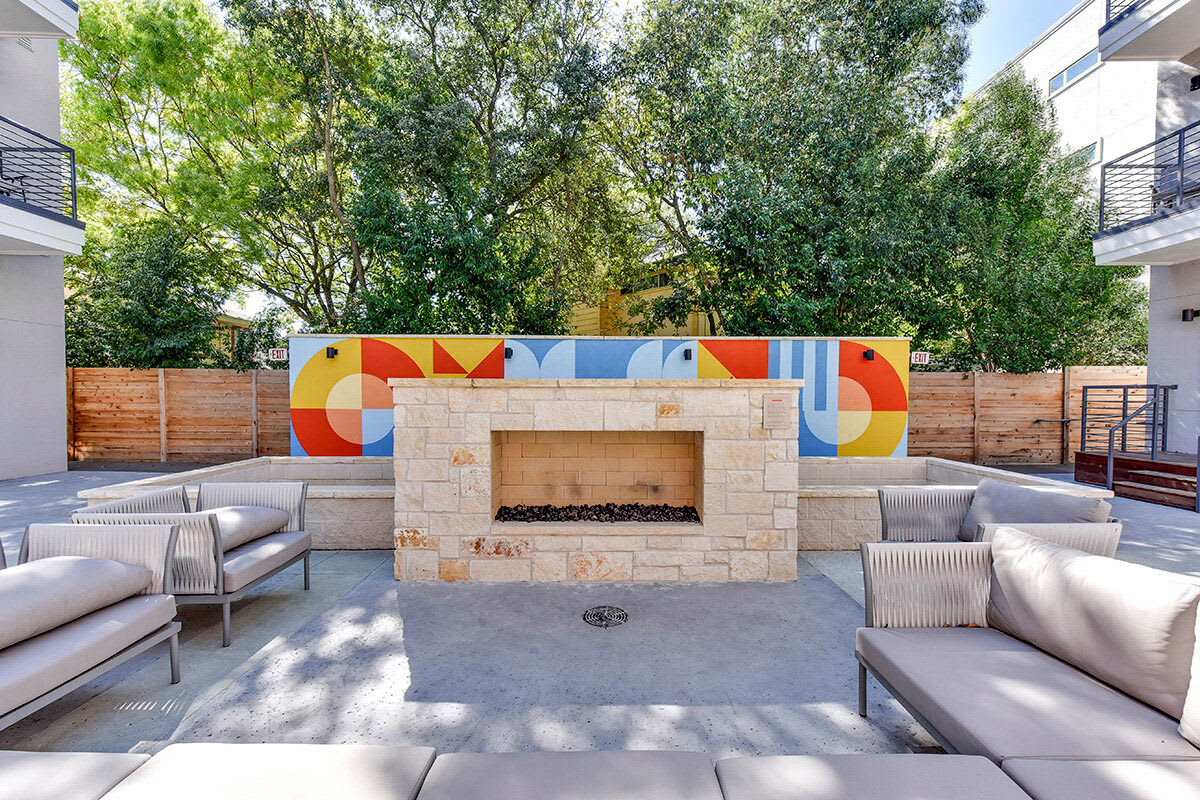 Outdoor fireplace seating area at St. Johns West in Austin, Texas