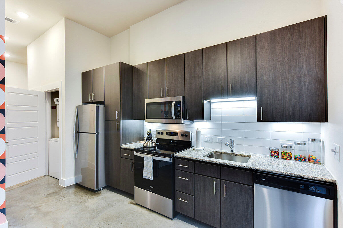 Modern kitchen with stainless steel appliances at St. Johns West in Austin, Texas