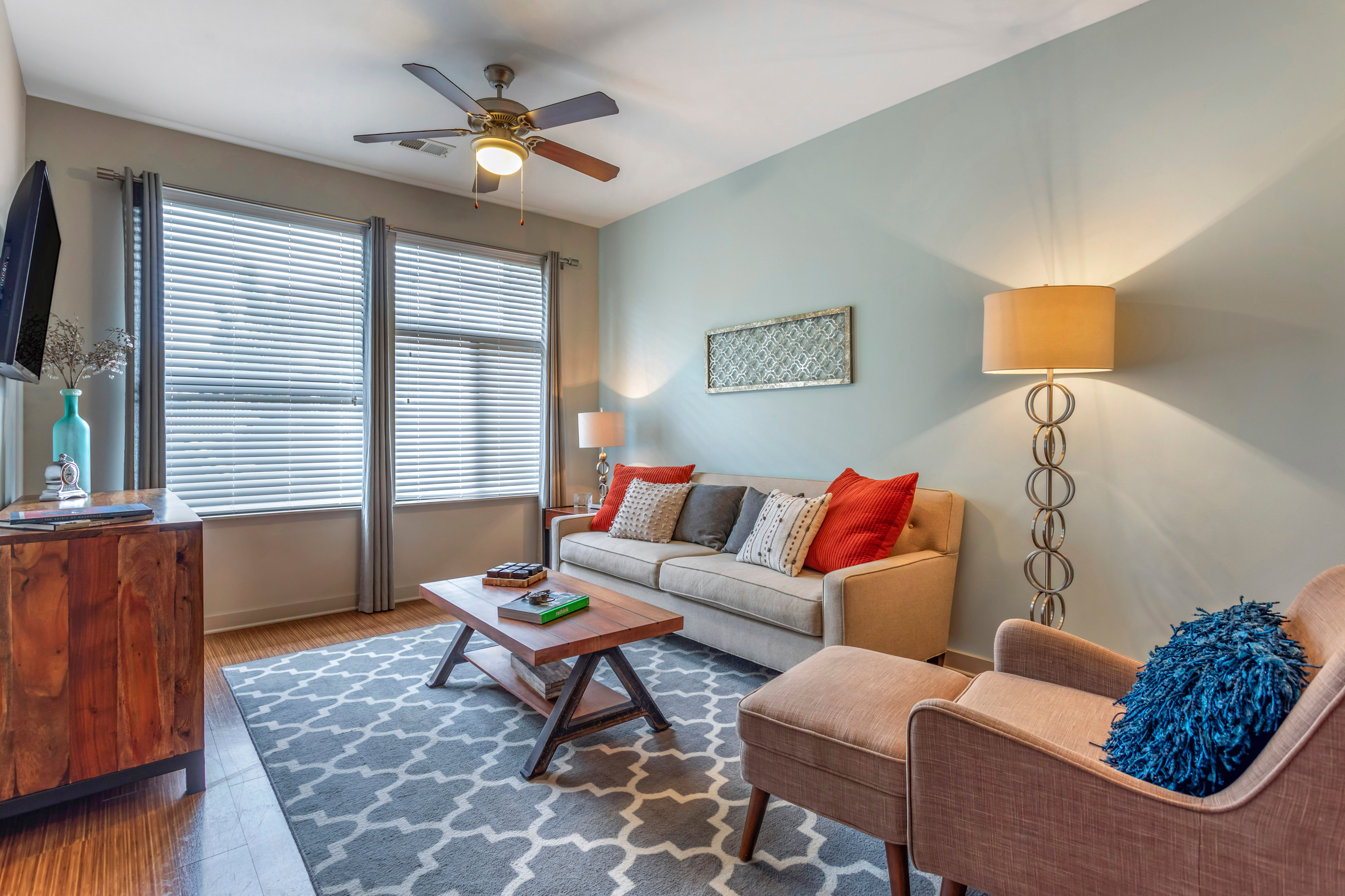 Well-furnished living space in a model home at Olympus Midtown in Nashville, Tennessee