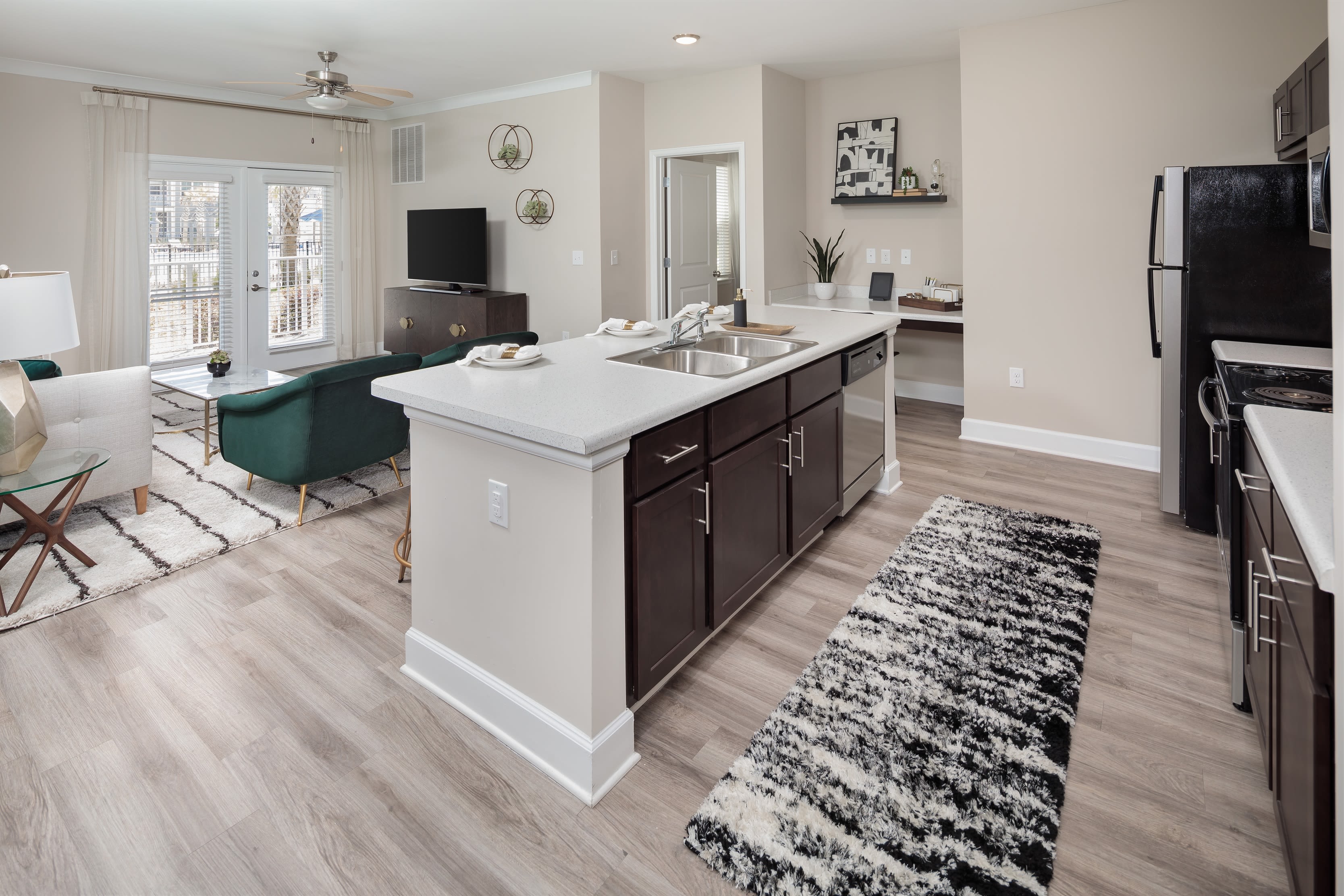 Large kitchen with dark cabinets and stainless steel appliances at The Isaac in Summerville, South Carolina