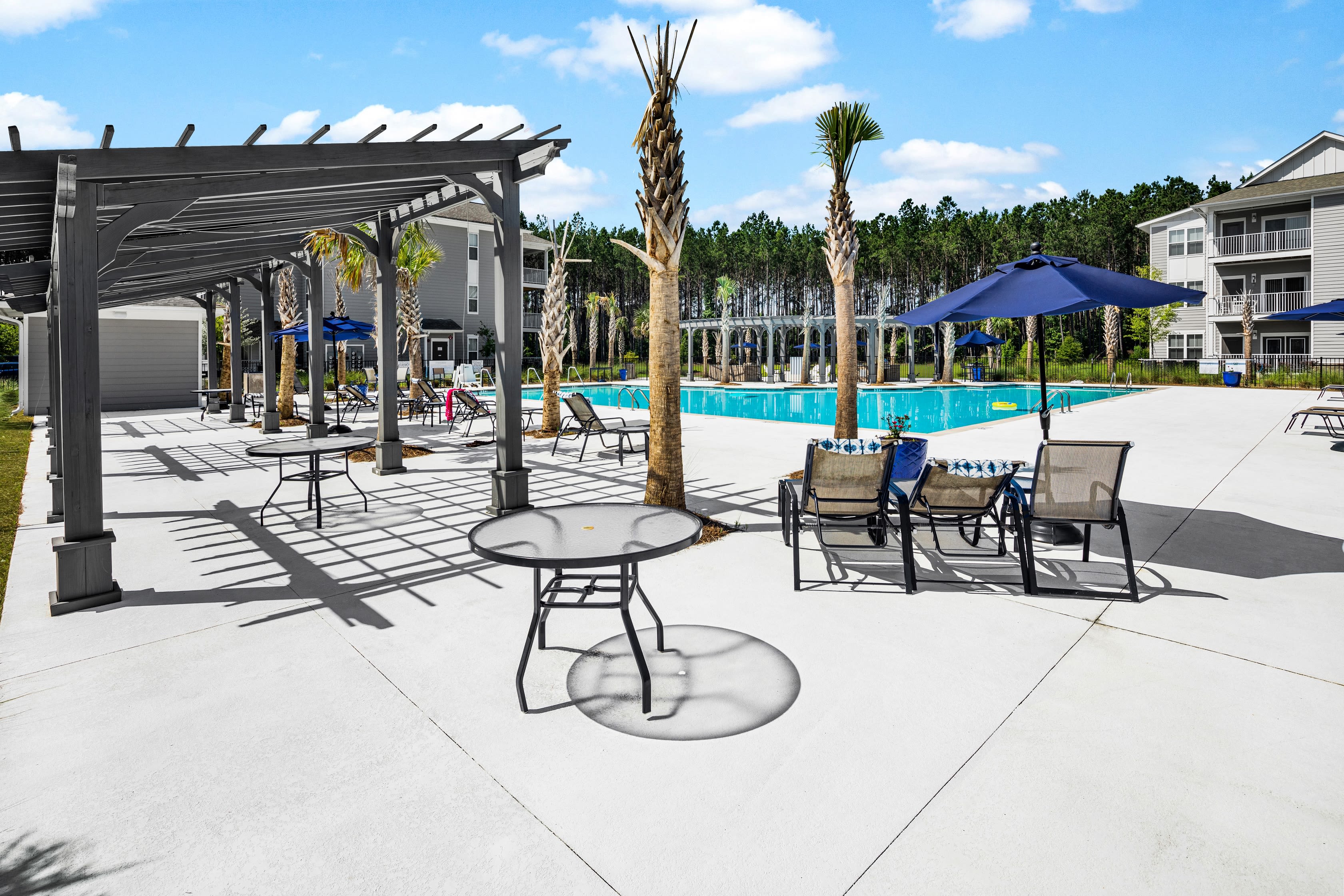 Outdoor grilling area with seating and places to cook poolside at The Isaac in Summerville, South Carolina