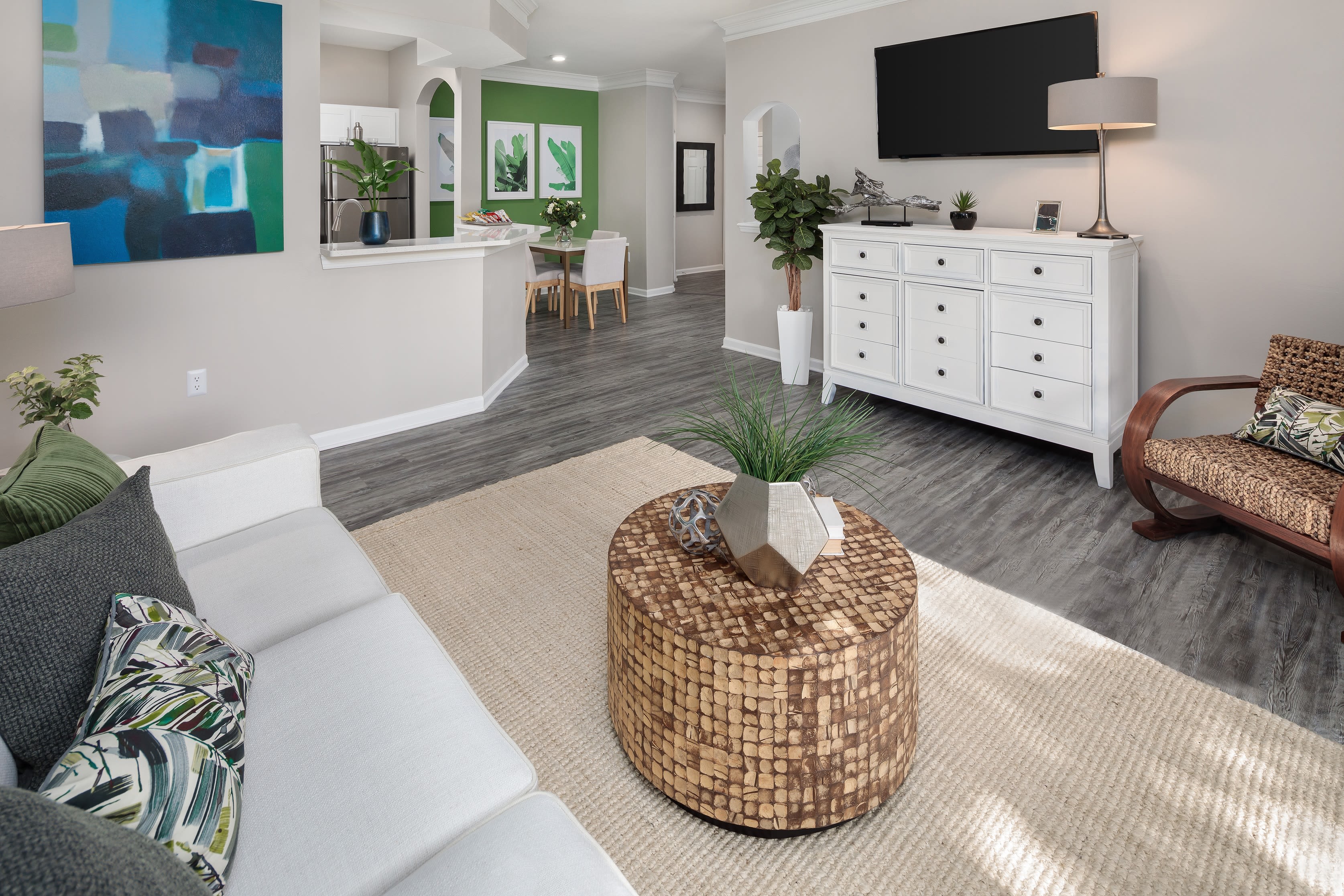 A furnished living room in a model apartment at Eddison at Deerwood Park in Jacksonville, Florida