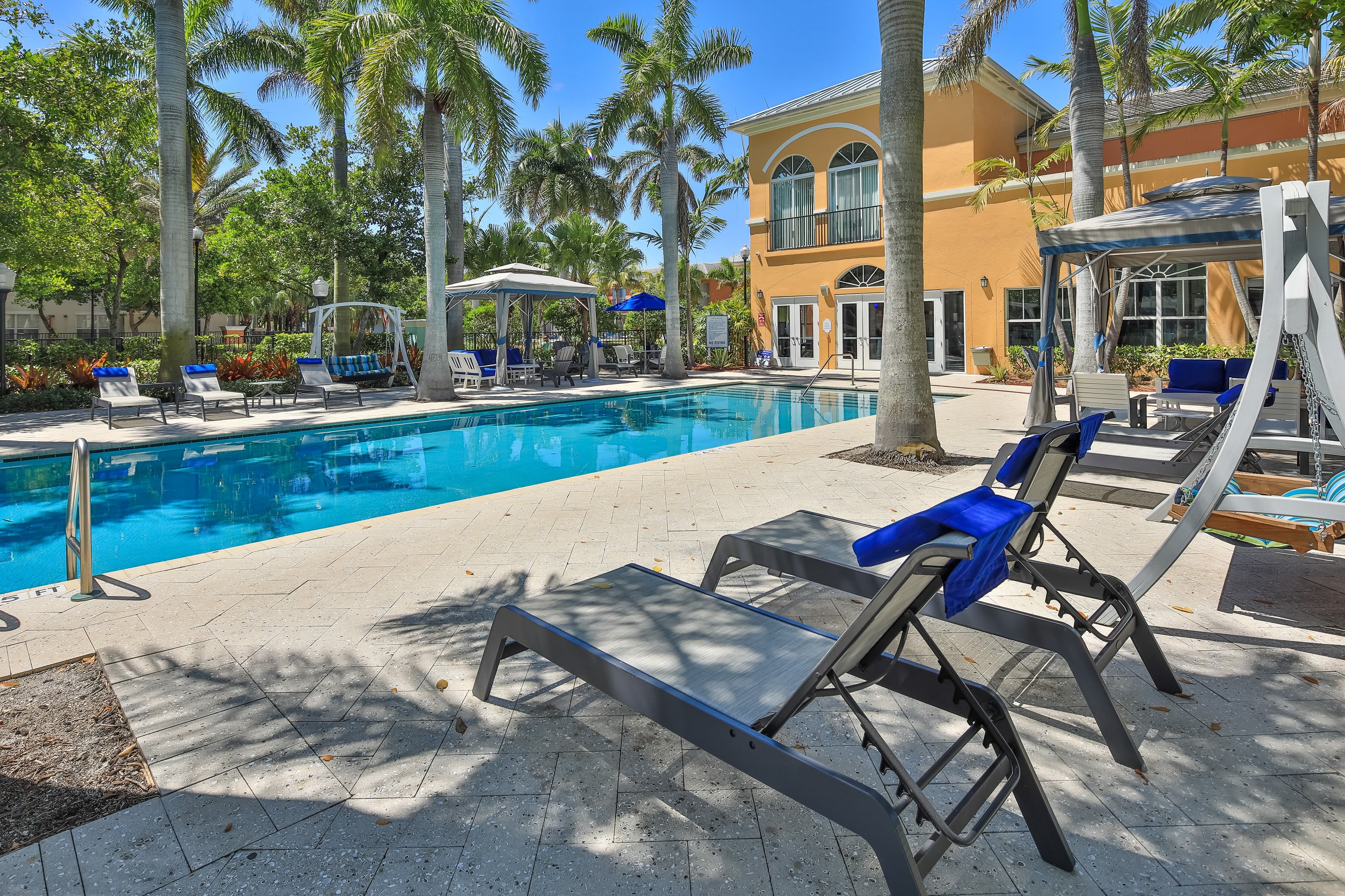 Gorgeous resort style swimming pool surrounded by lounge chairs at The Pearl in Ft Lauderdale, Florida
