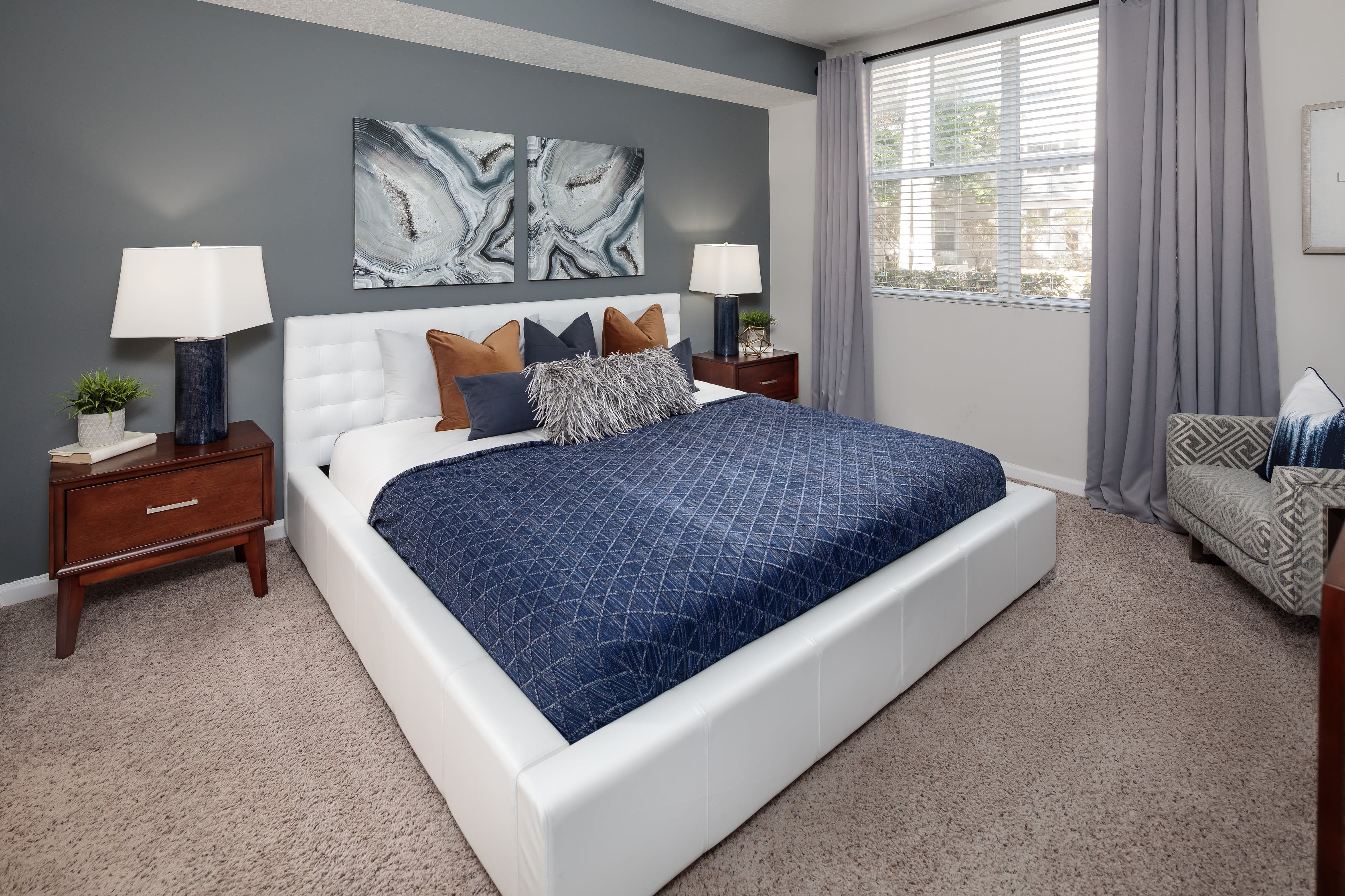 Modern bedroom with carpet and a ceiling fan in model home at The Pearl in Ft Lauderdale, Florida
