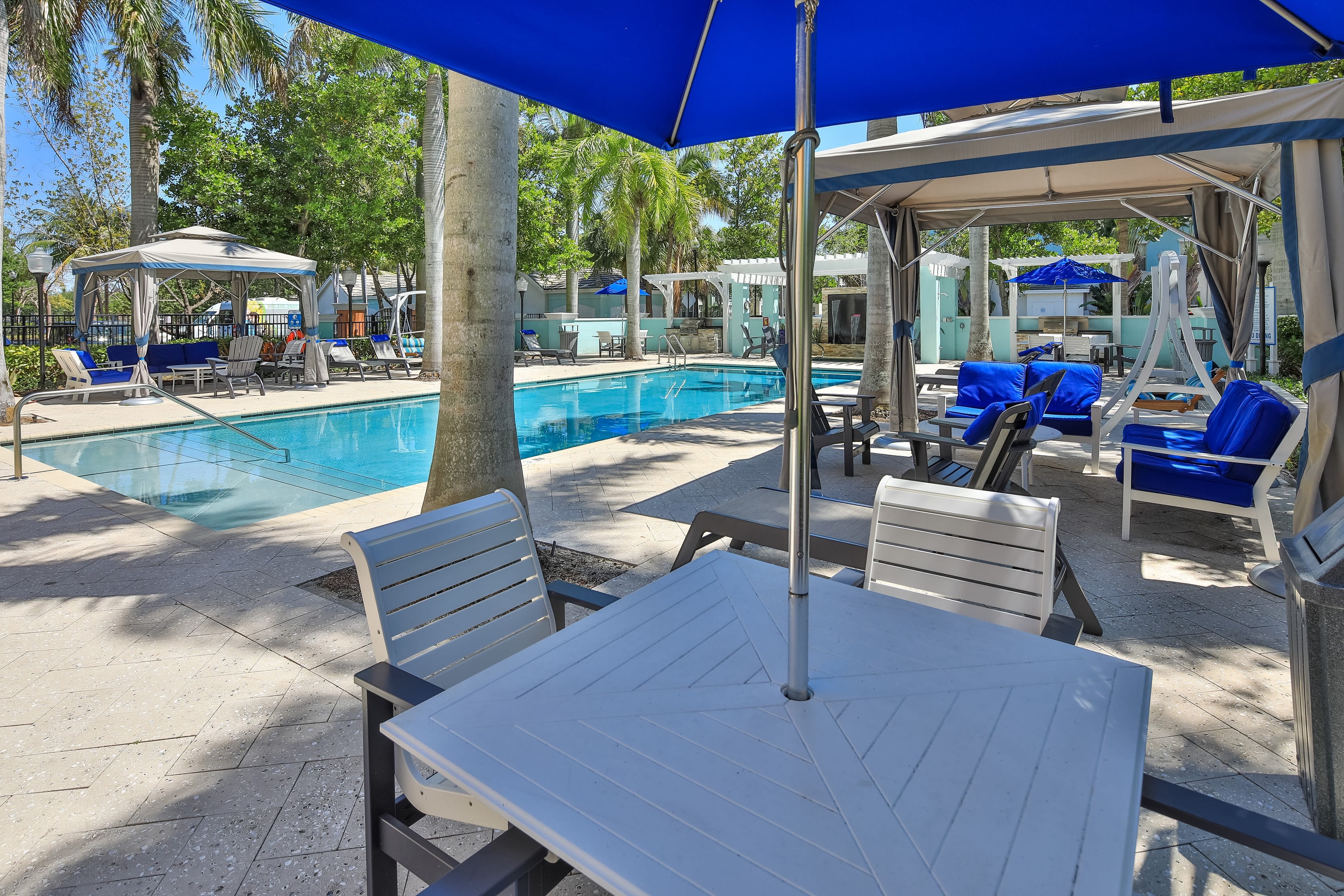 Pool and shaded seating at the barbecue area with gas grills at The Pearl in Ft Lauderdale, Florida