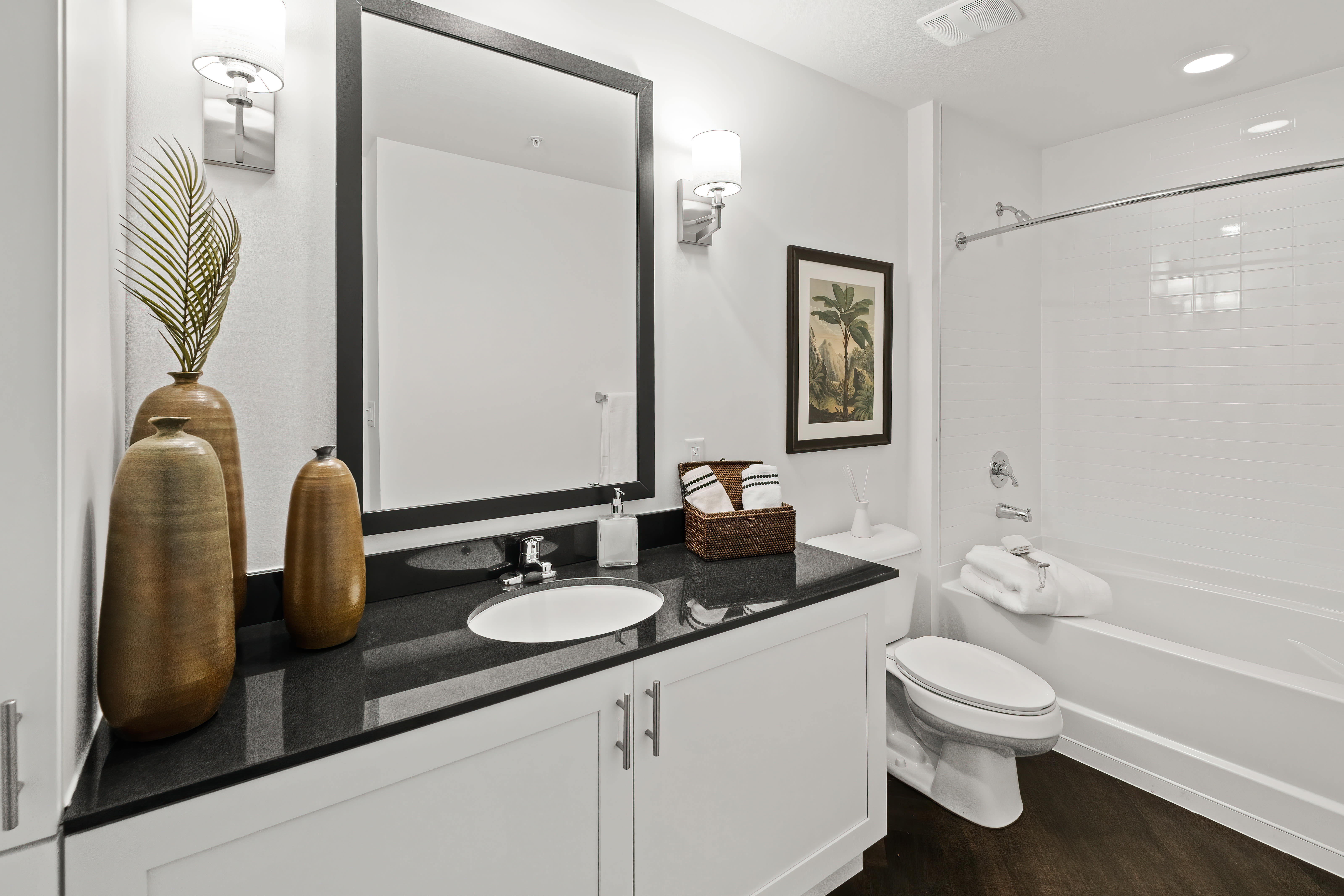 Well lit bathroom with oversize vanity at Oceanside Lantana in Lantana, Florida