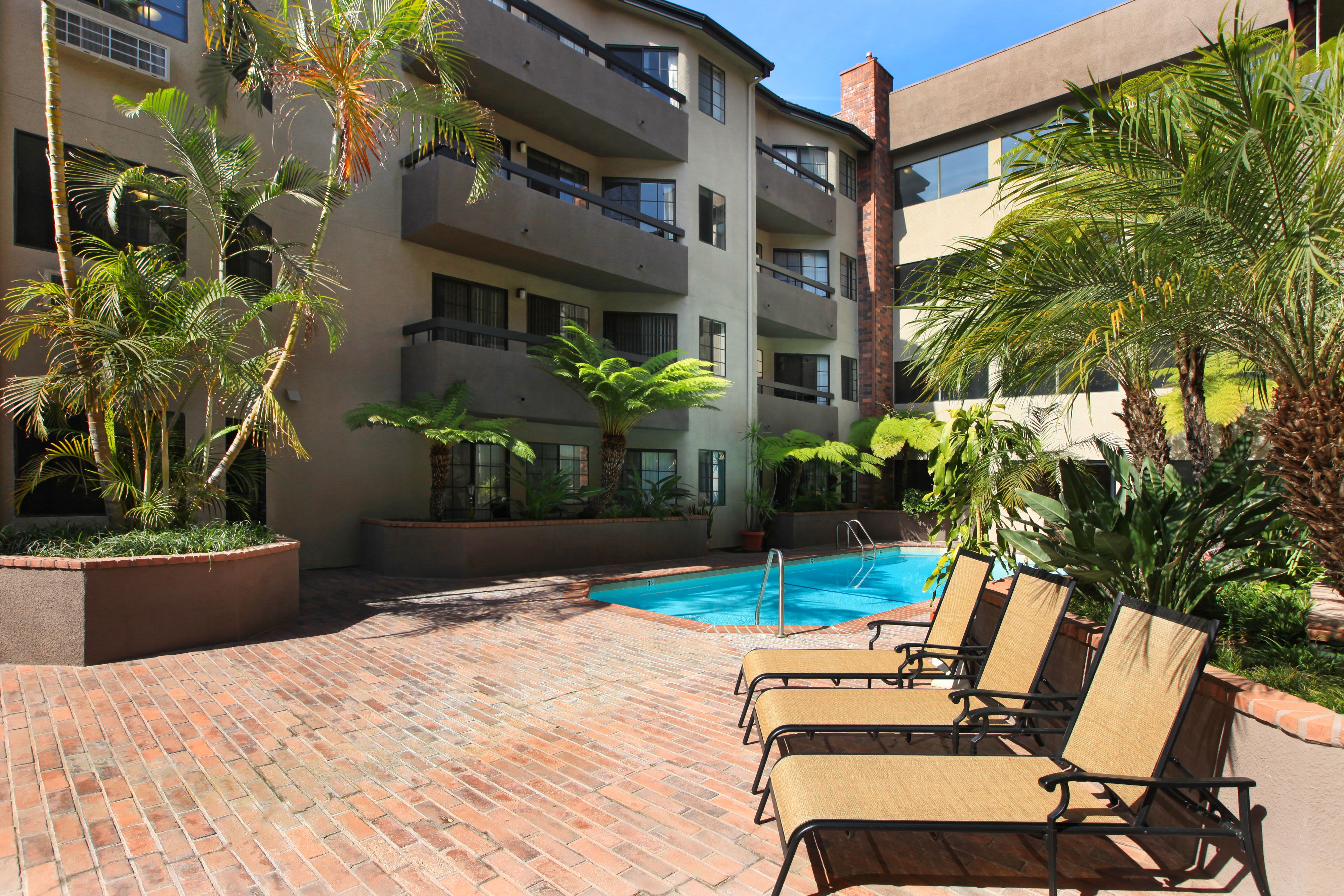 Lounge chairs by the pool at Savoy West Apartments in Los Angeles, California
